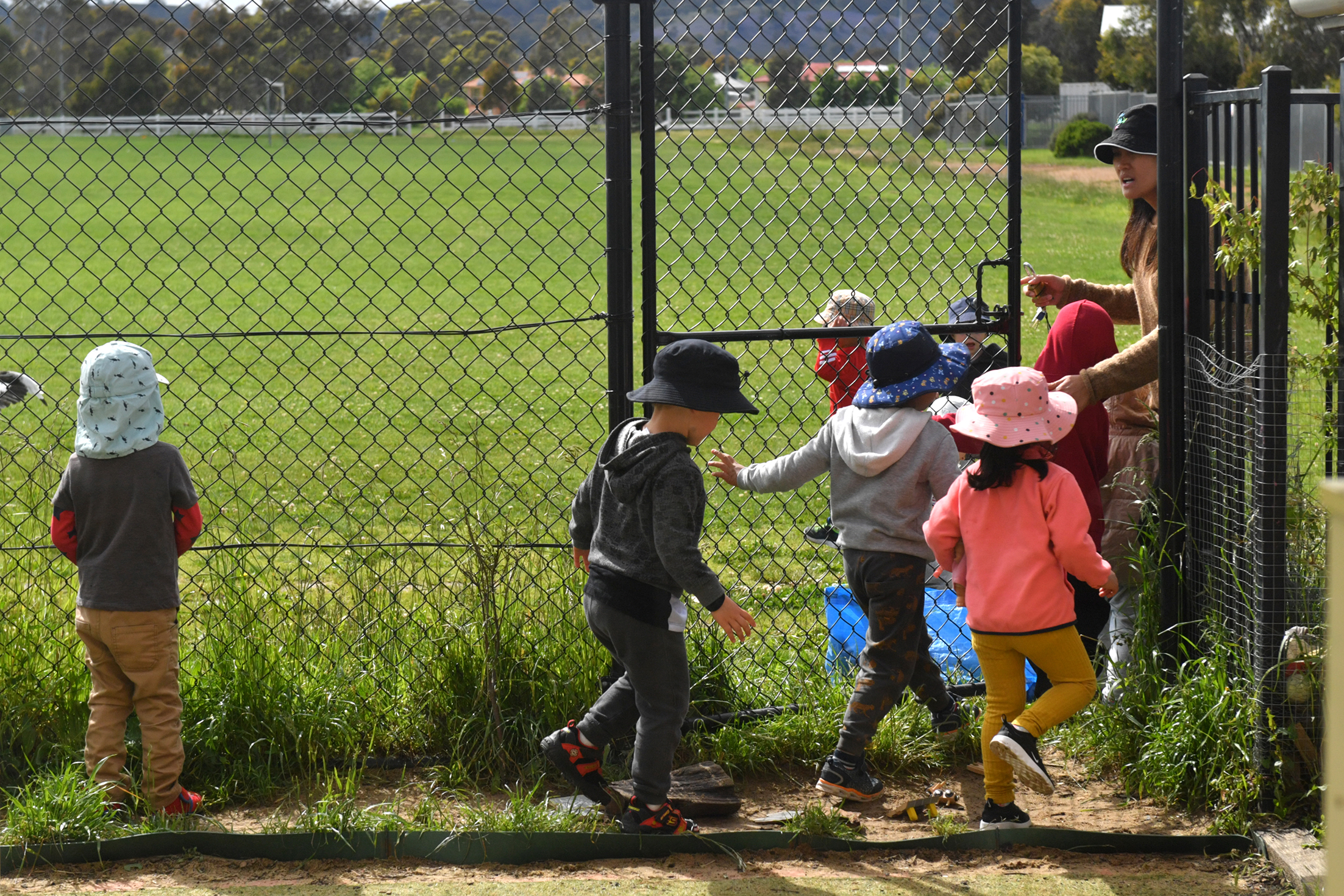 Kids being let through a gate.