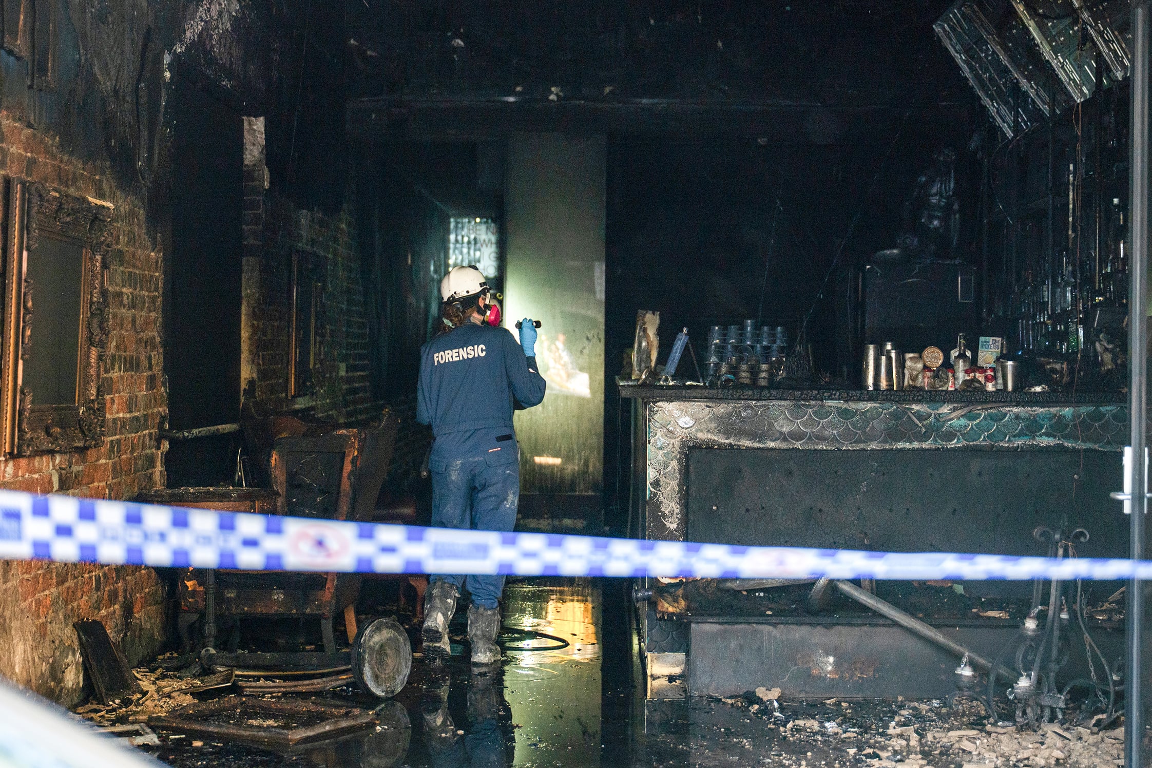 Police search a suspected firebombing of a Chapel Street bar in Prahran, Victoria.