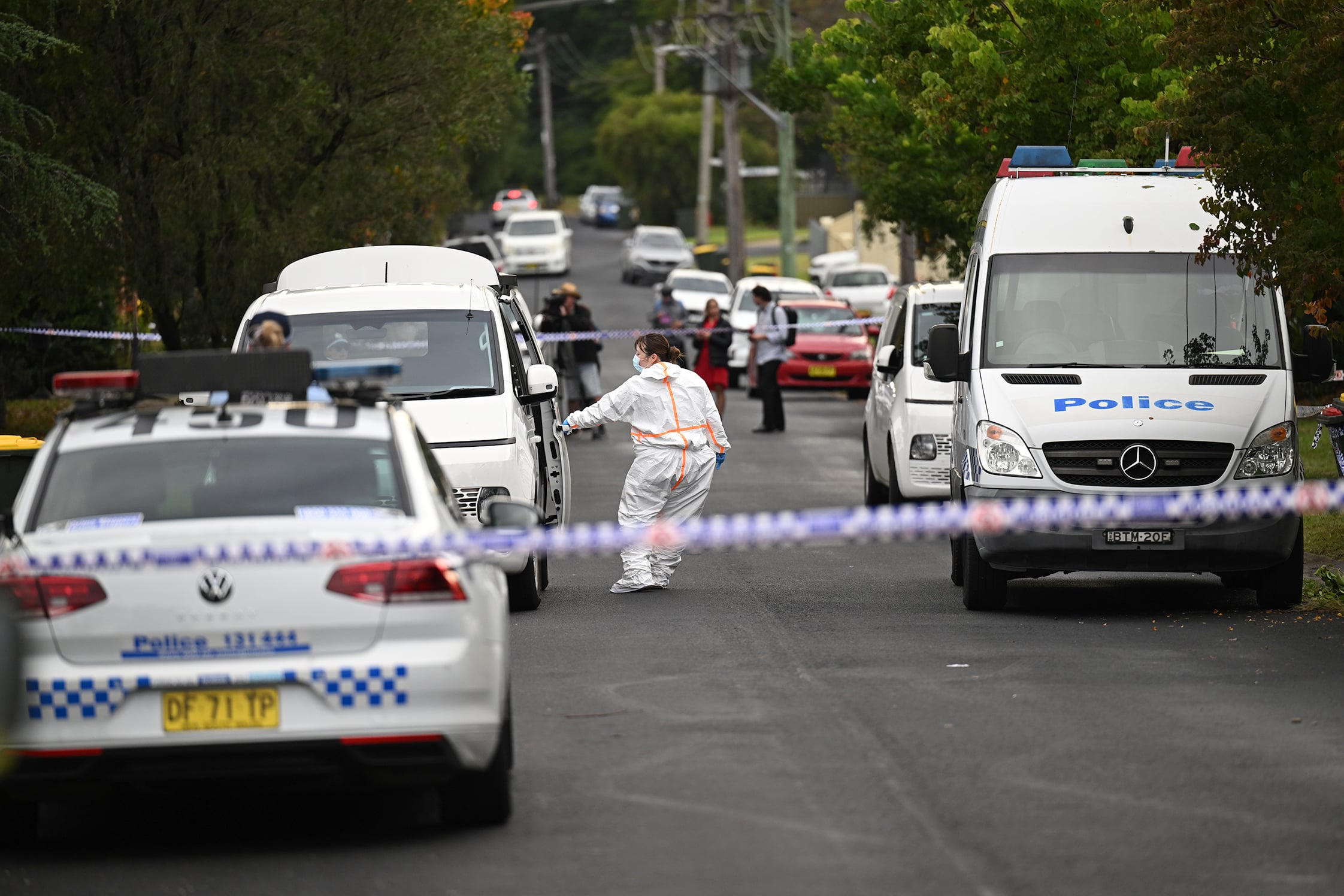 Police and forensic officers at the scene of a triple murder in Sydney.