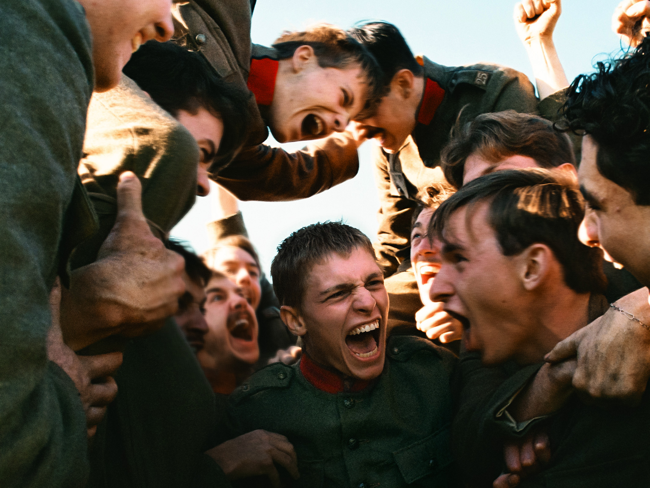 A crowd of man cheer.