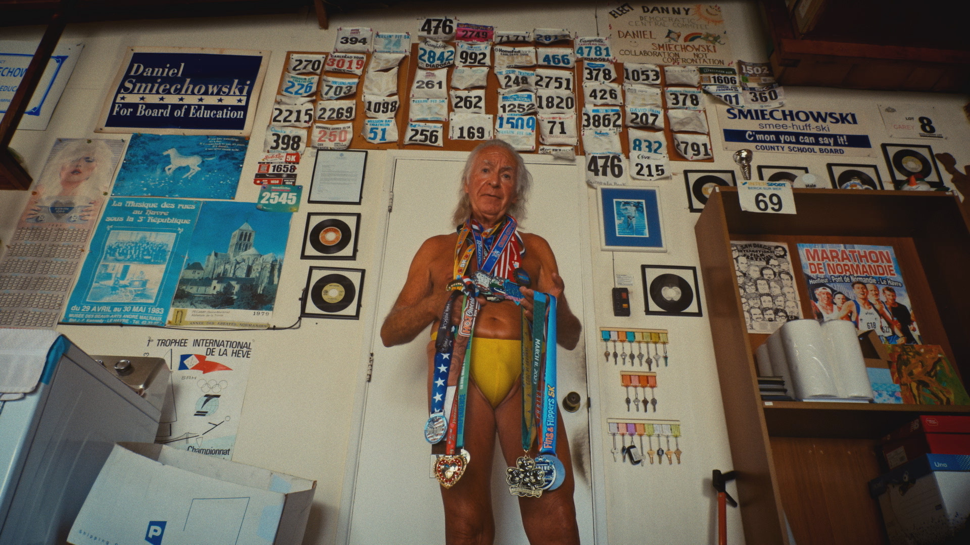 Danny Smiechowski in his underwear and holding medals.