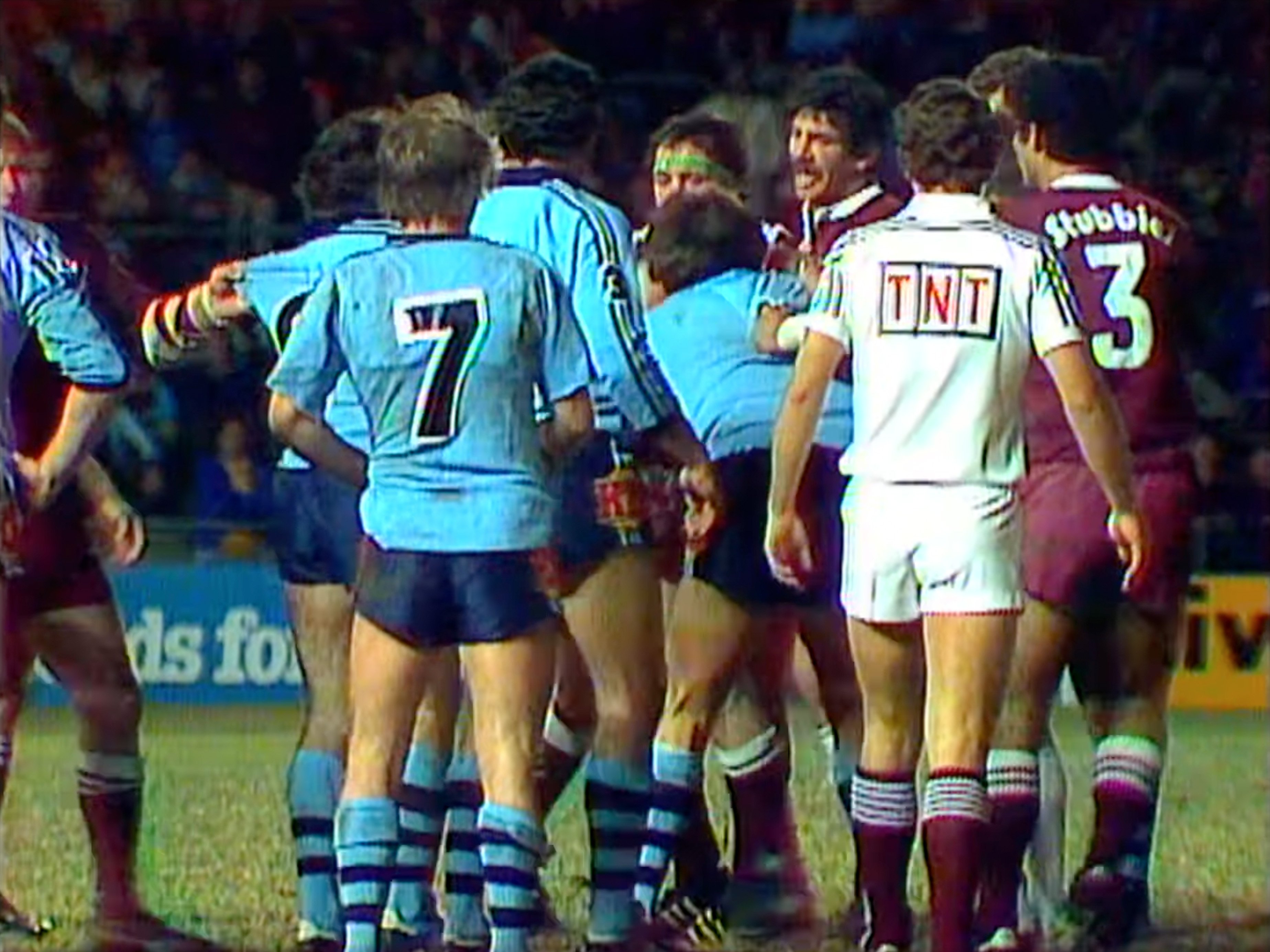 Queensland and New South Wales players on the rugby pitch.
