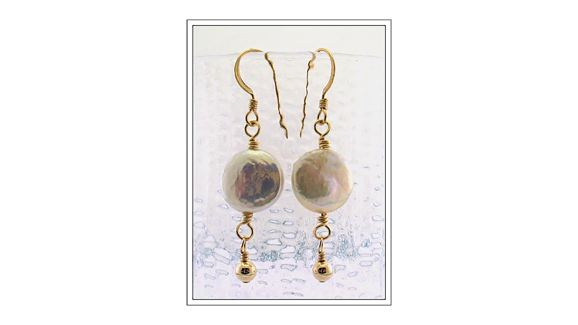 Two pearl earrings.