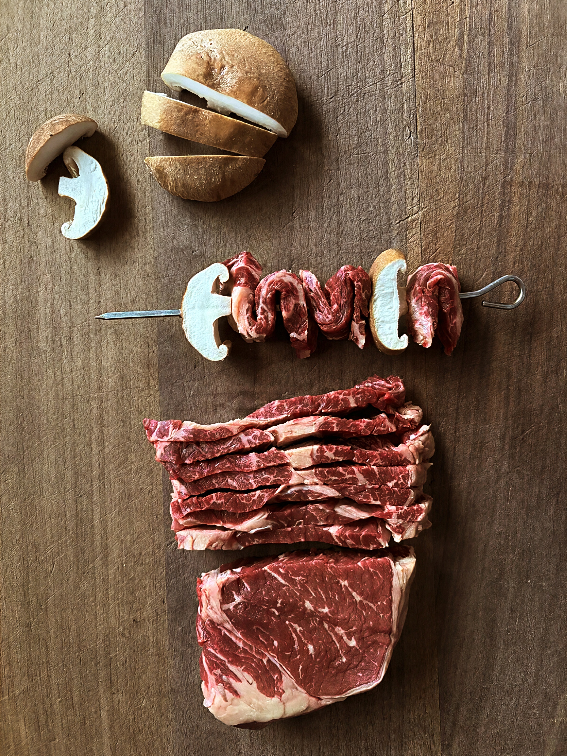 Beef skewers with mushroom.