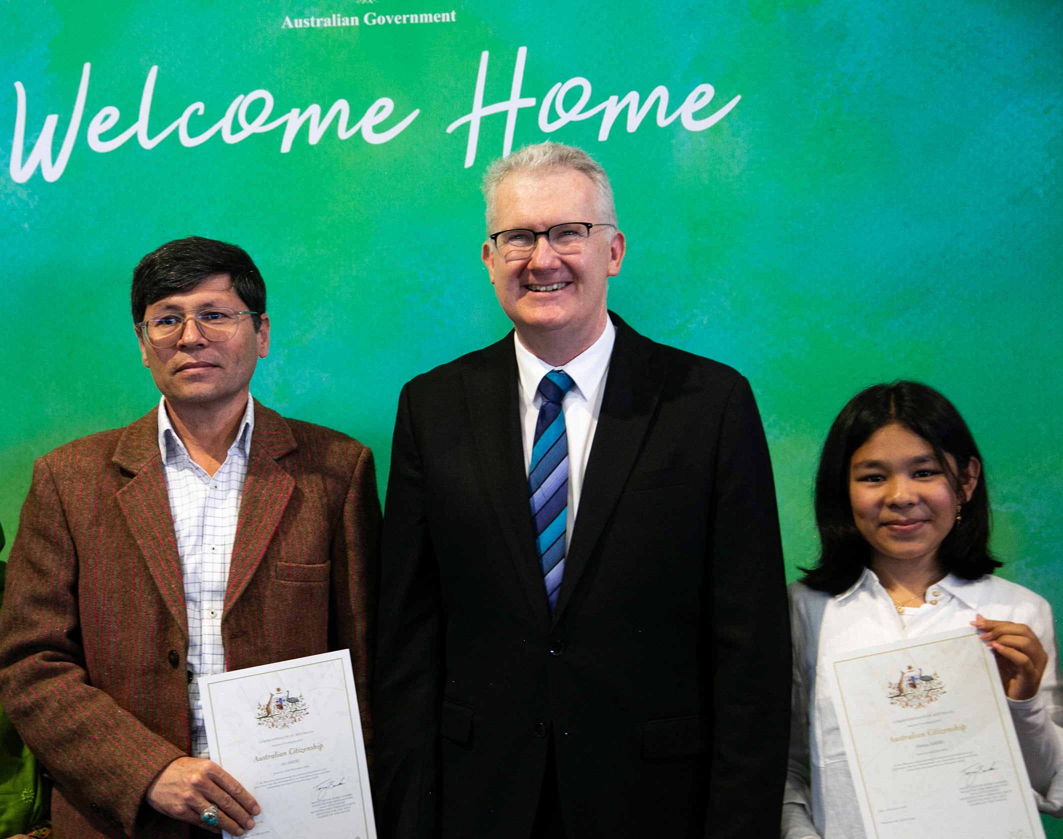 Ali Amiri and daughter Helen flank Home Affairs Minister Tony Burke, at their citizenship.