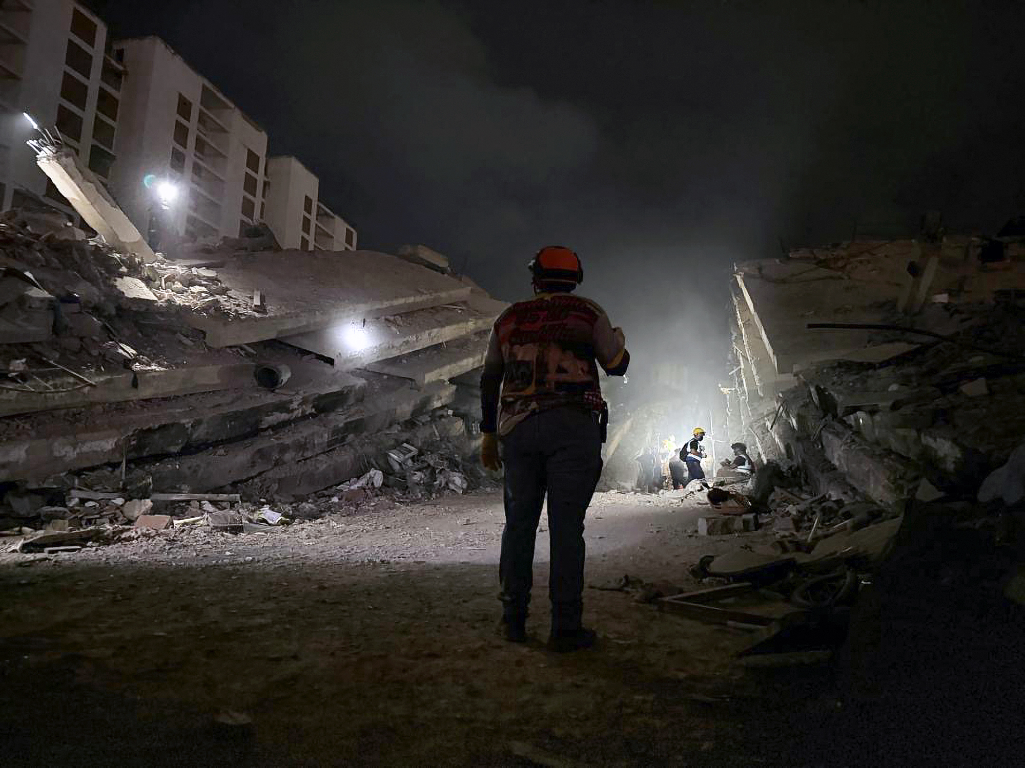 Rescue workers survey the rubble following deadly earthquakes in La Guaira, Venezuela. 