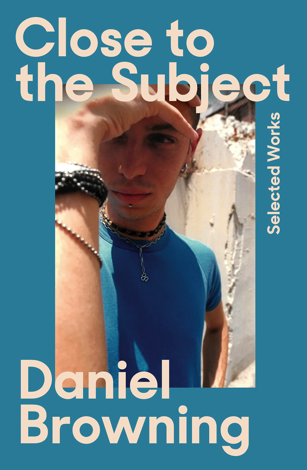 Book cover: a young man with his hand over face.