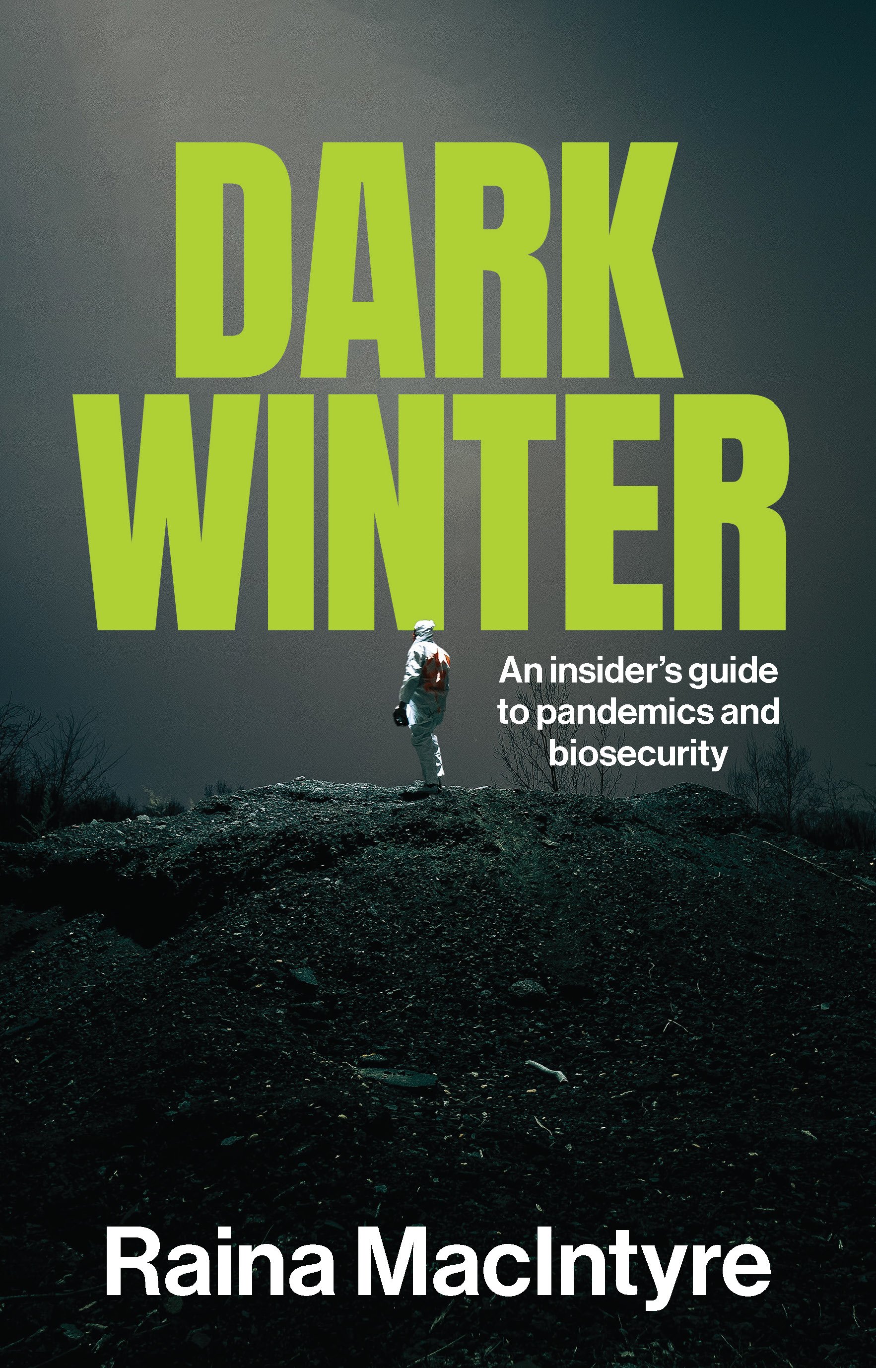 A dark long shot of a barren landscape shows a single figure in a white hazmat suit facing away from the viewier, a ray of light is over them in contrast to the rest of the dark image. The book's title is large and in all-capped green font.