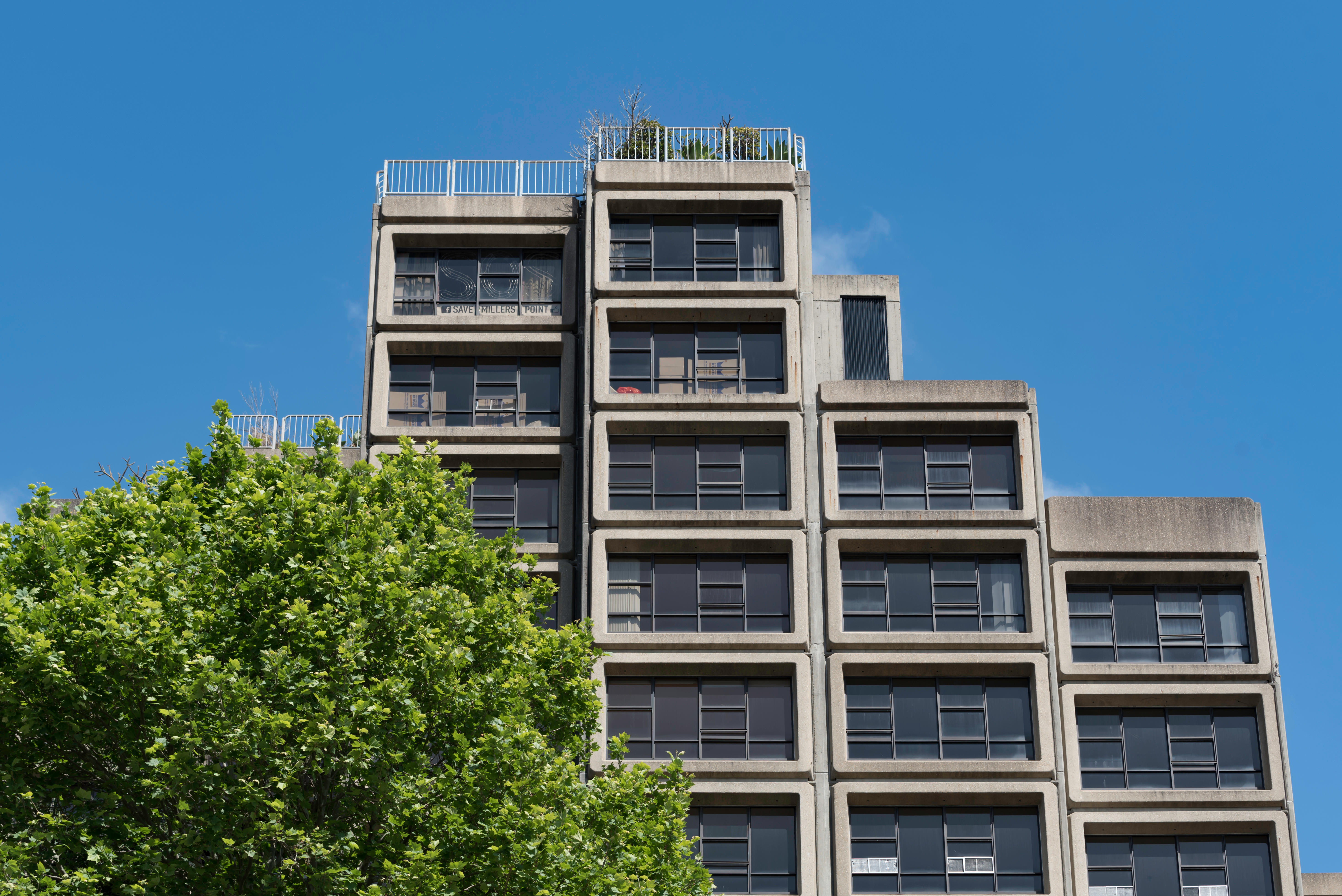 A brutalist building under a blue sky.