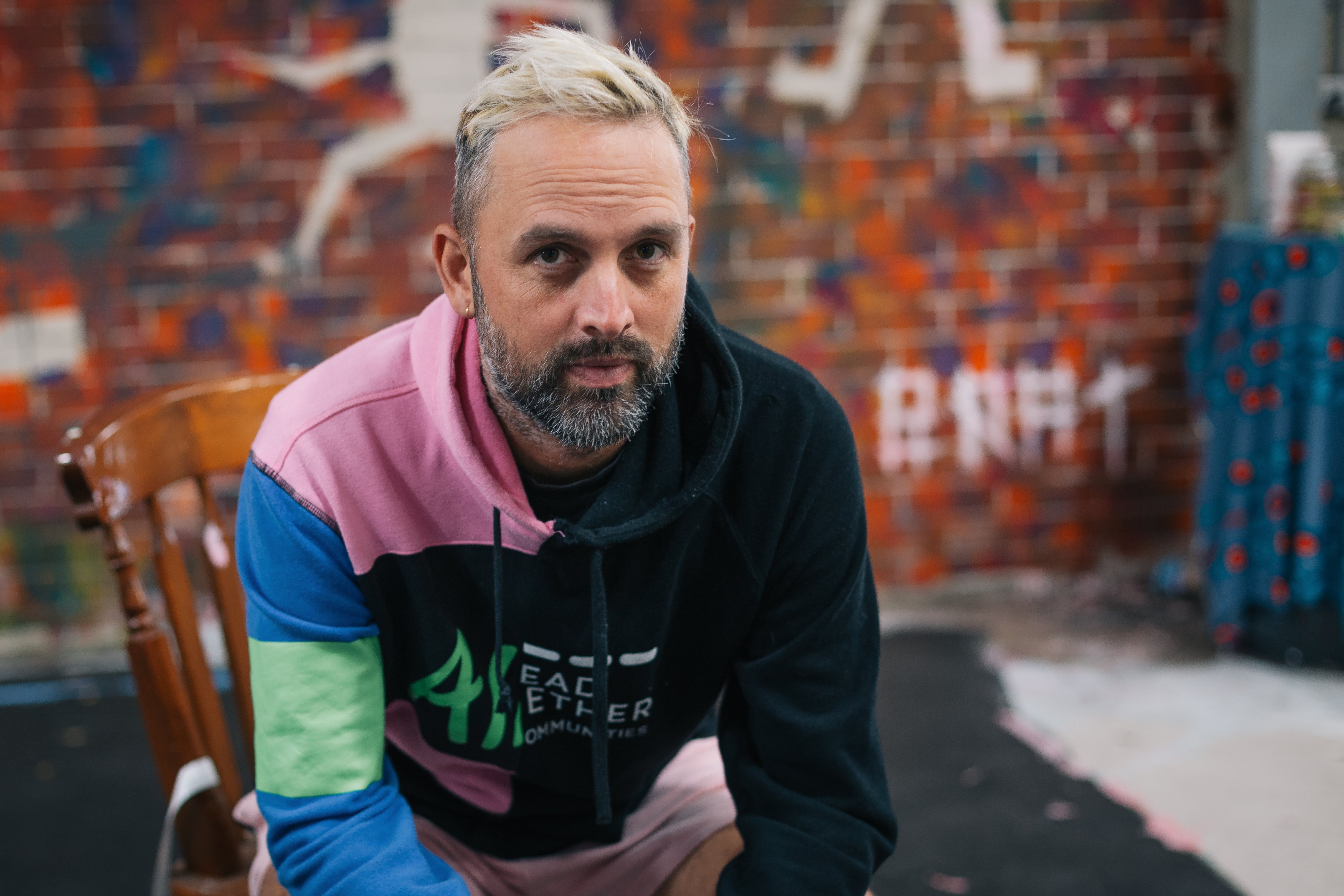 A man with bleach blonde hair and a greying beard.