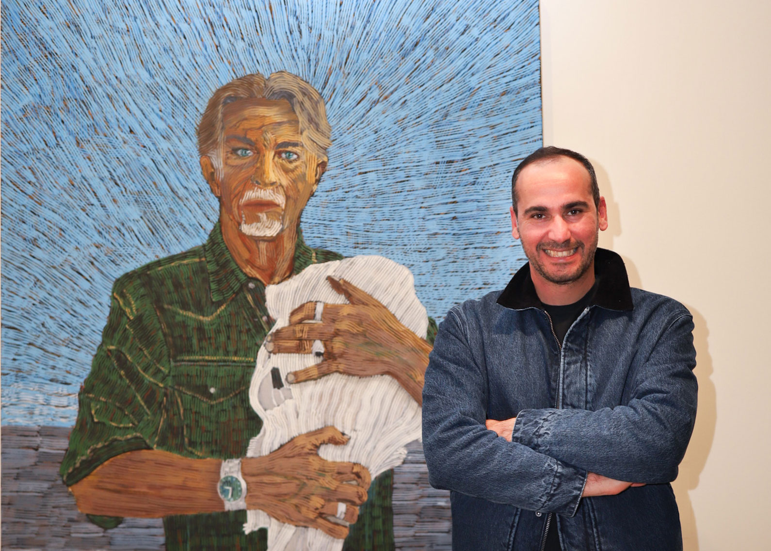 Mostafa Azimitabar in front of his Archibald-nominated portrait of Angus McDonald. 