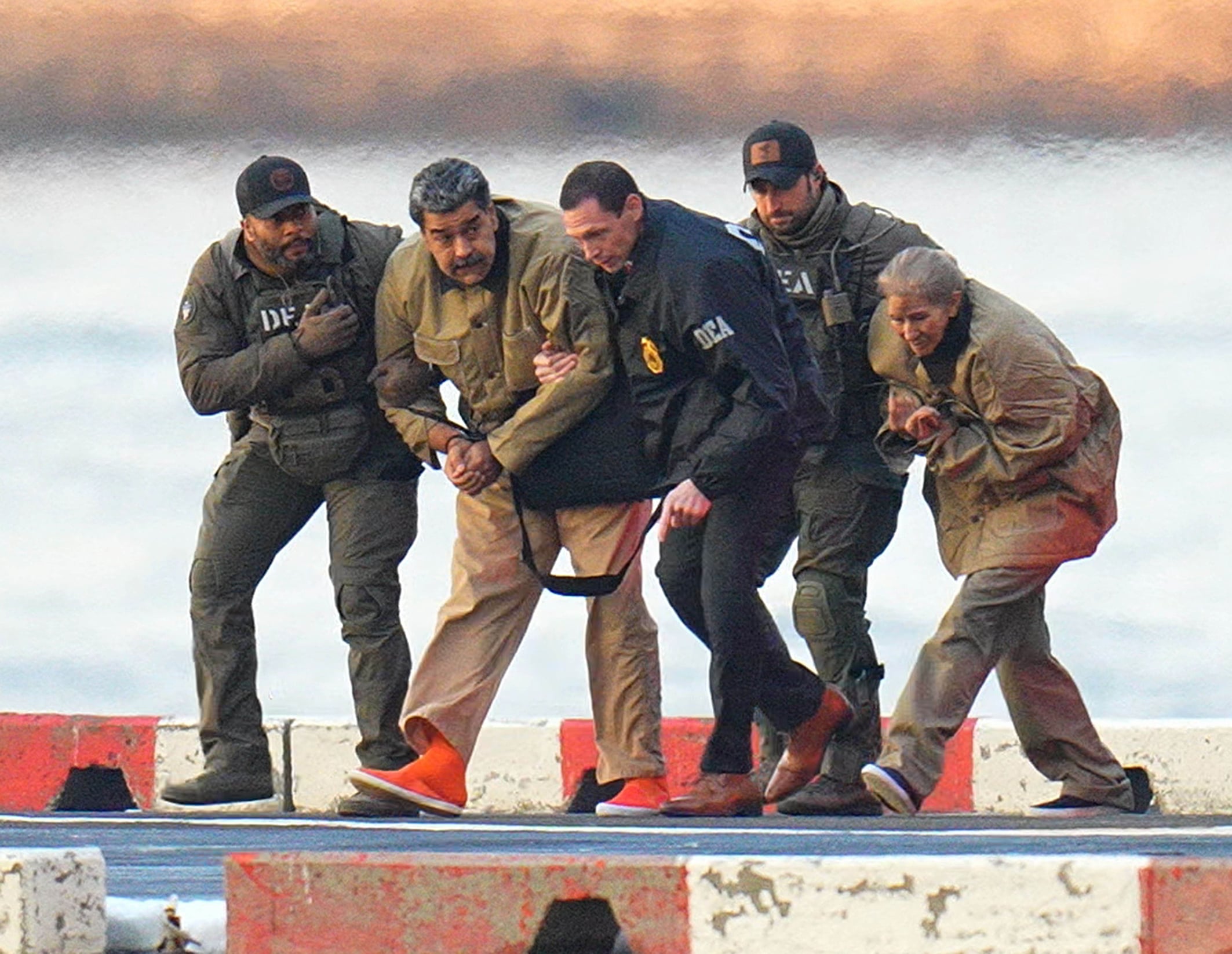 US federal agents escort Venezuelan president Nicolás Maduro and his wife, Cilia Flores, to detention in New York.