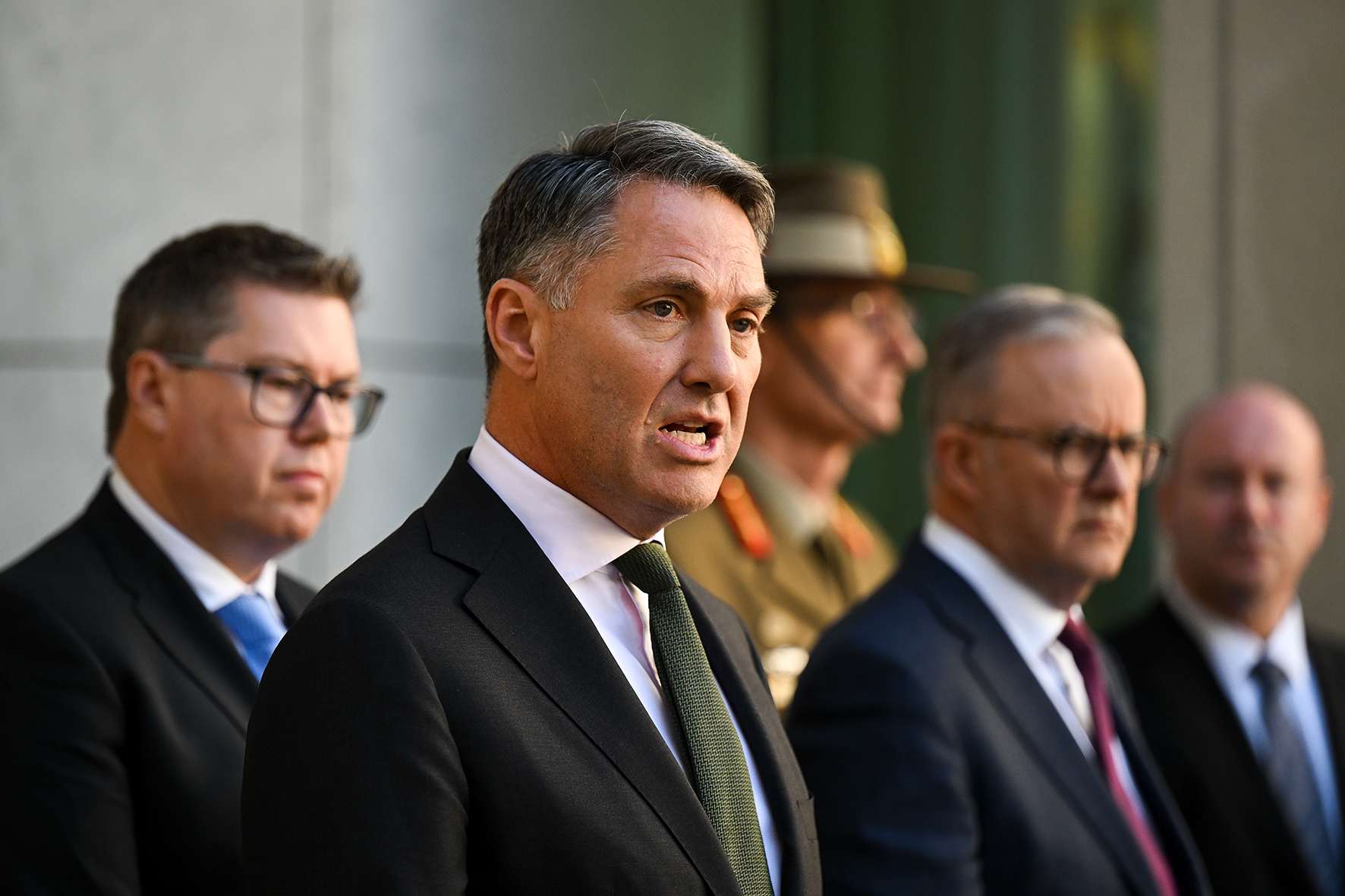 Richard Marles is dressed in a suit as he speaks at a press conference. 