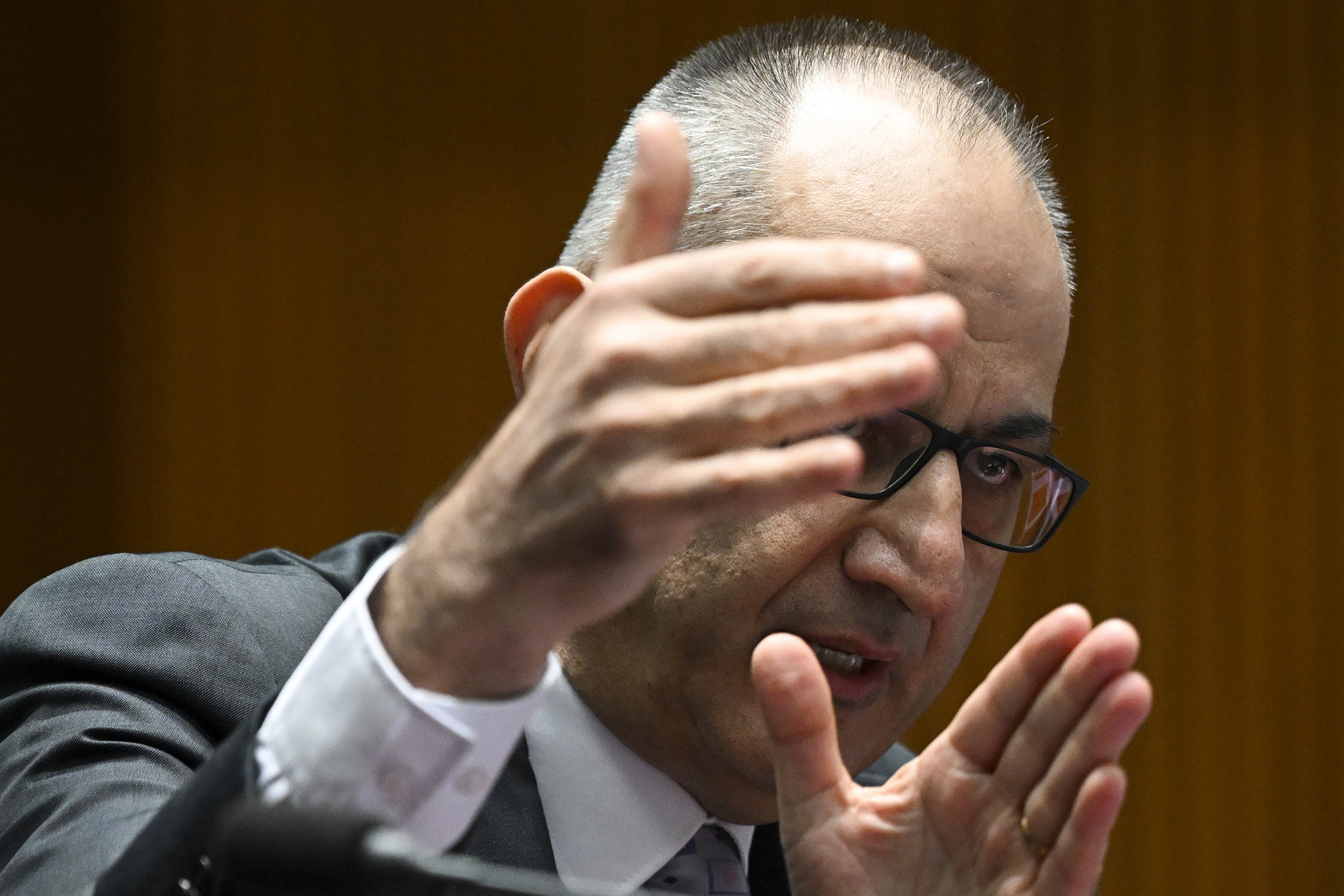 Mike Pezzullo with his hands raised as he speaks.