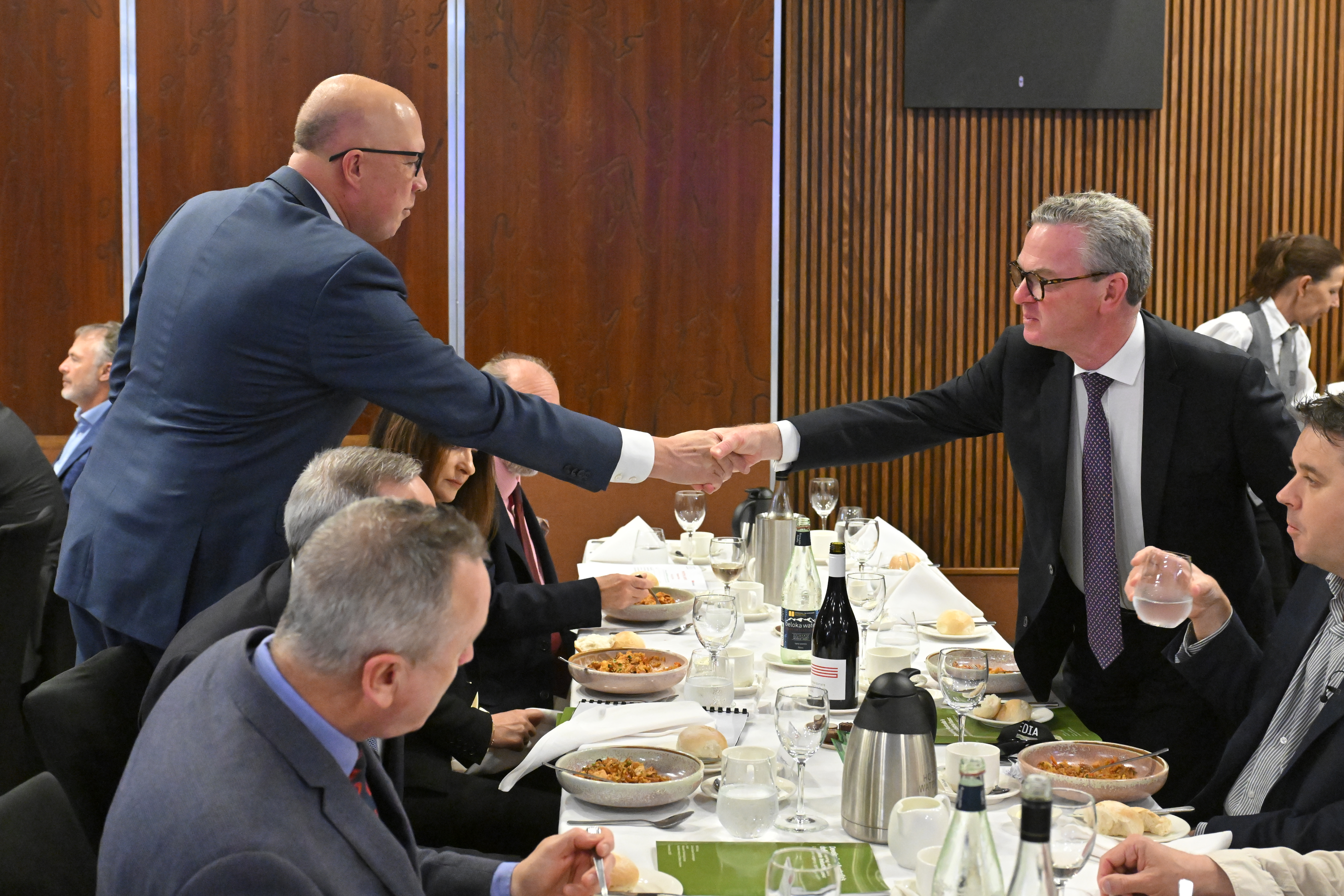 Opposition Leader Peter Dutton greets lobbyist and former Liberal minister Christopher Pyne at a National Press Club event.