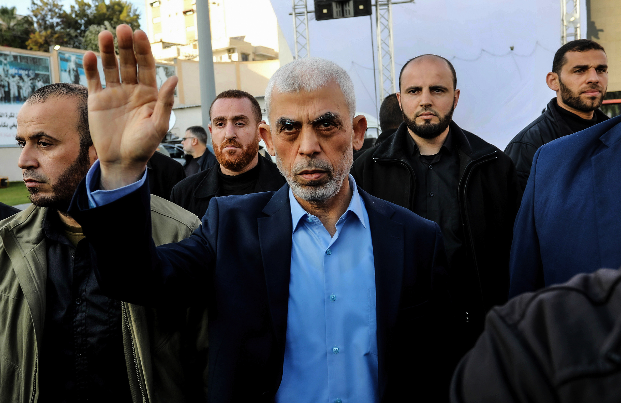 A man with his hand raised.