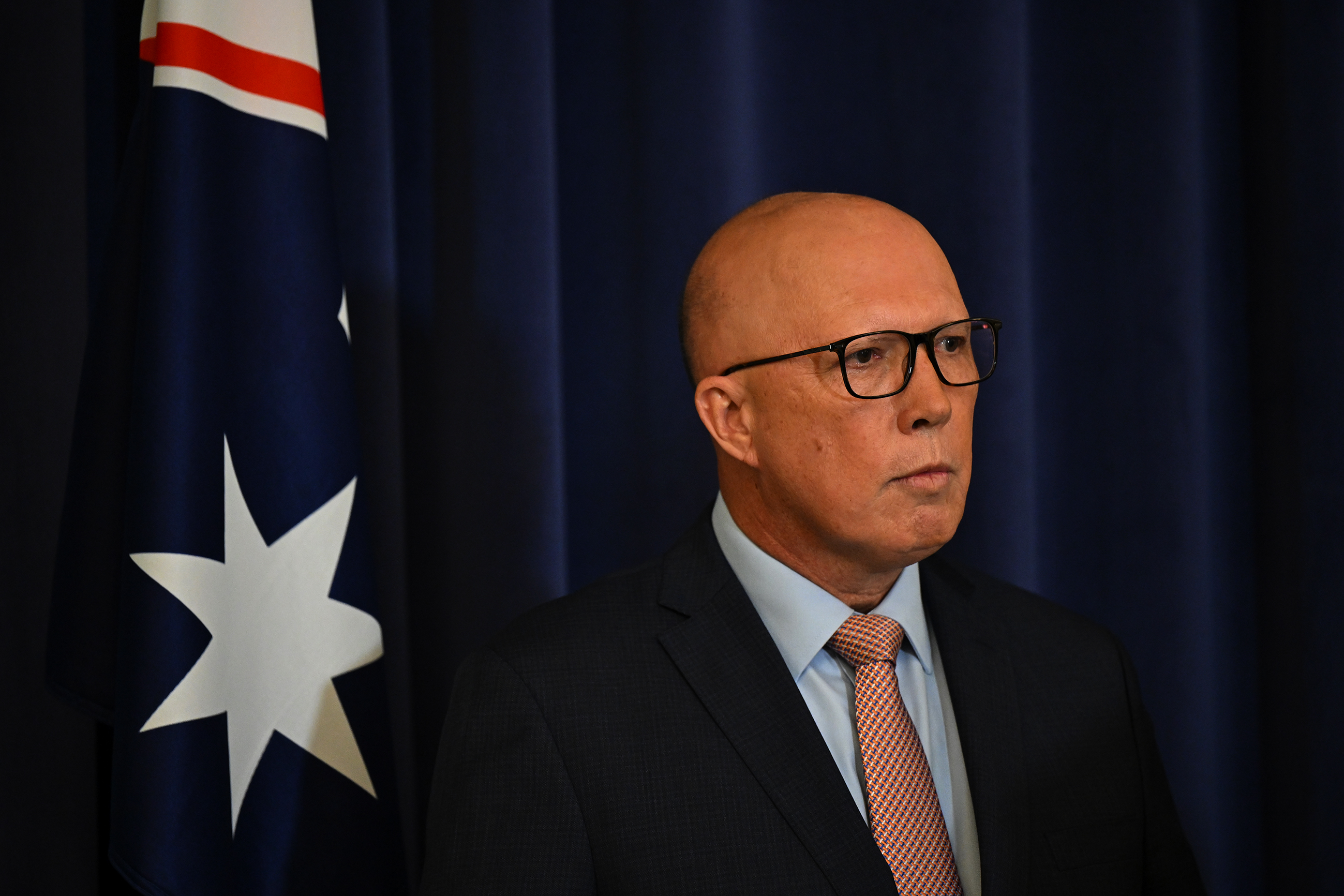 Peter Dutton beside the Australian flag.
