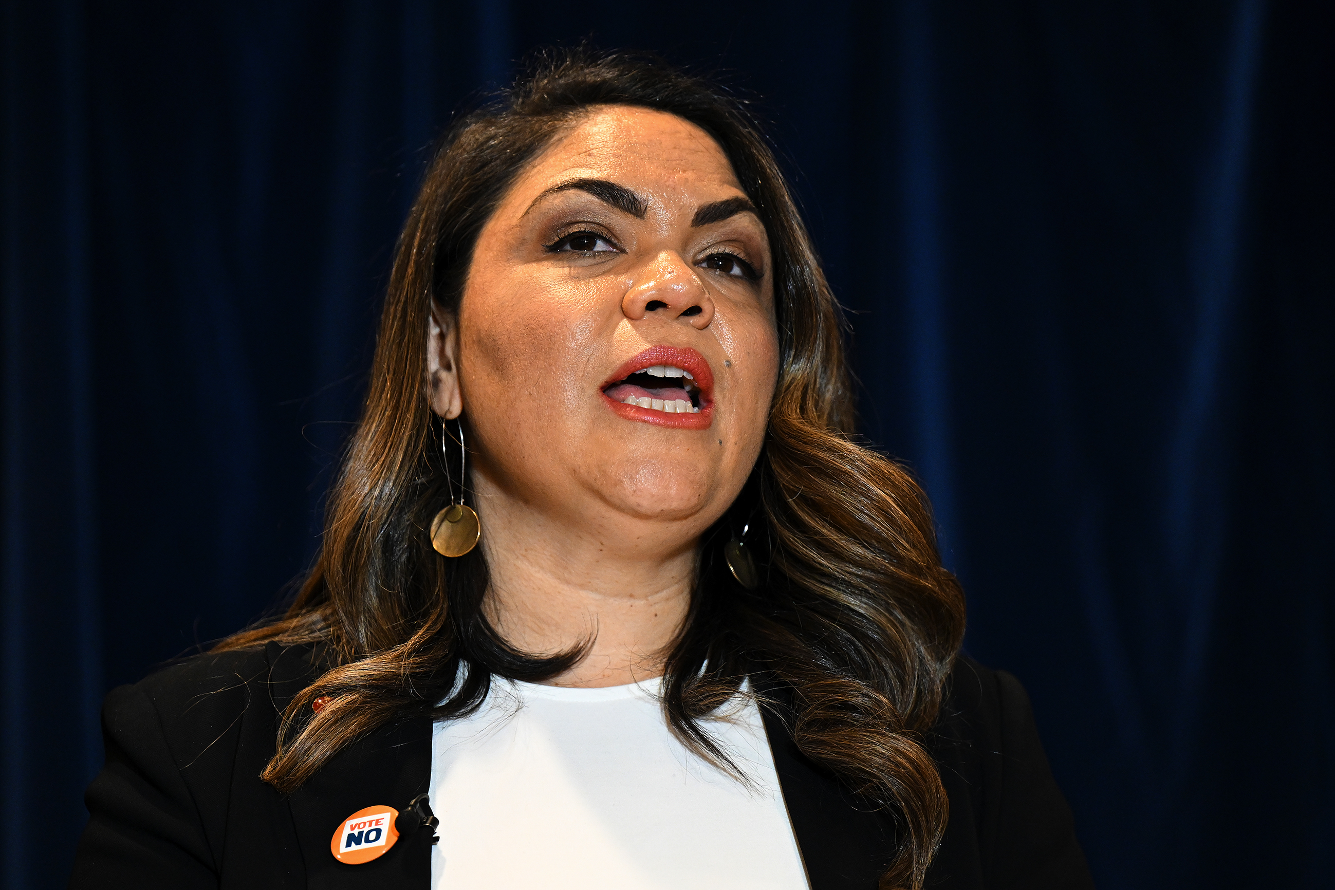 Jacinta Nampijinpa Price wearing a black blazer with a “vote no” badge attached.