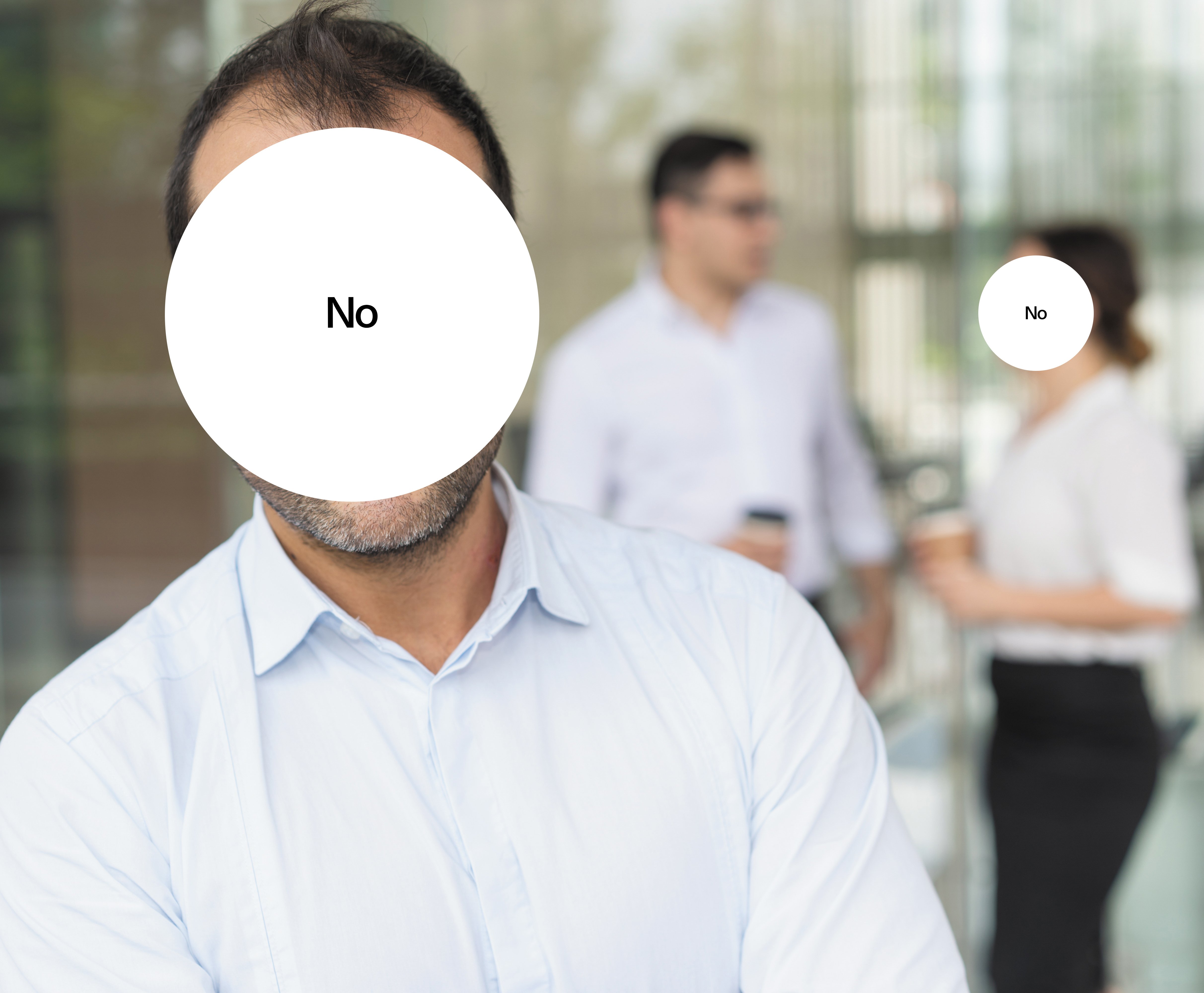 A man wearing a business shirt. His face is concealed by a white circle with "no" written in the middle. 