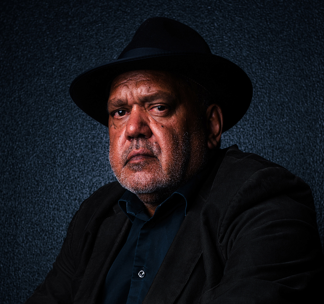 Portrait photograph of a man wearing a black hat matched with a corduroy blazer.