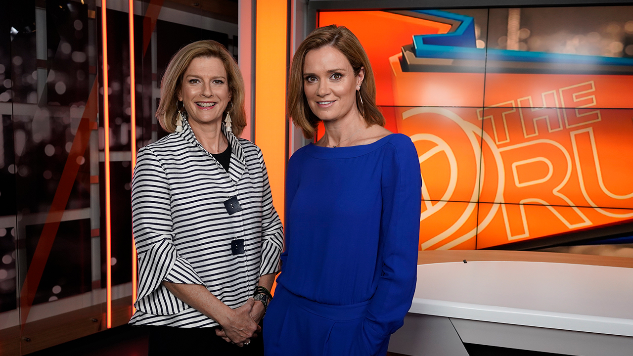 Two television presenters on set.