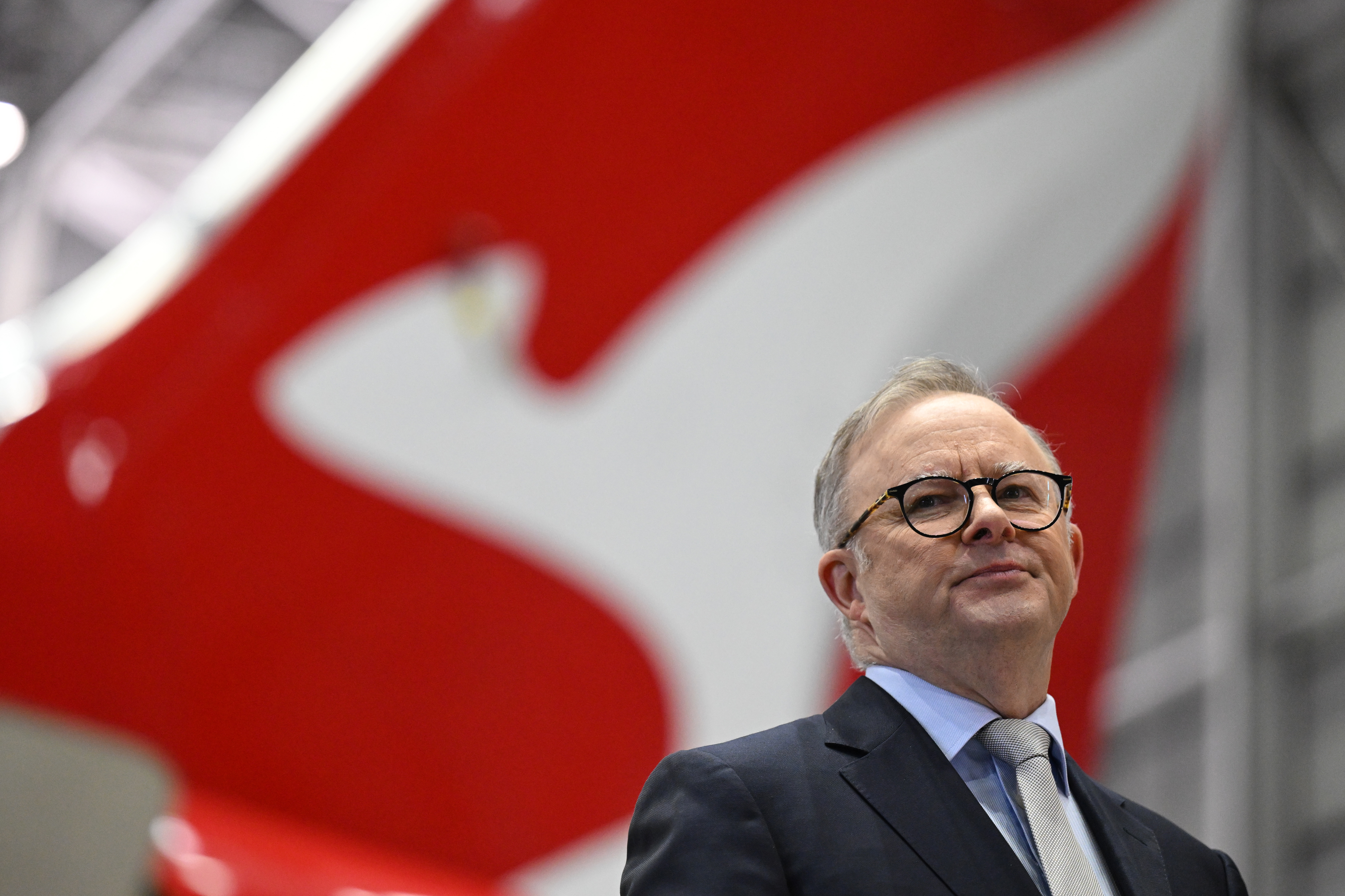 Anthony Albanese in front of a Qantas plane.