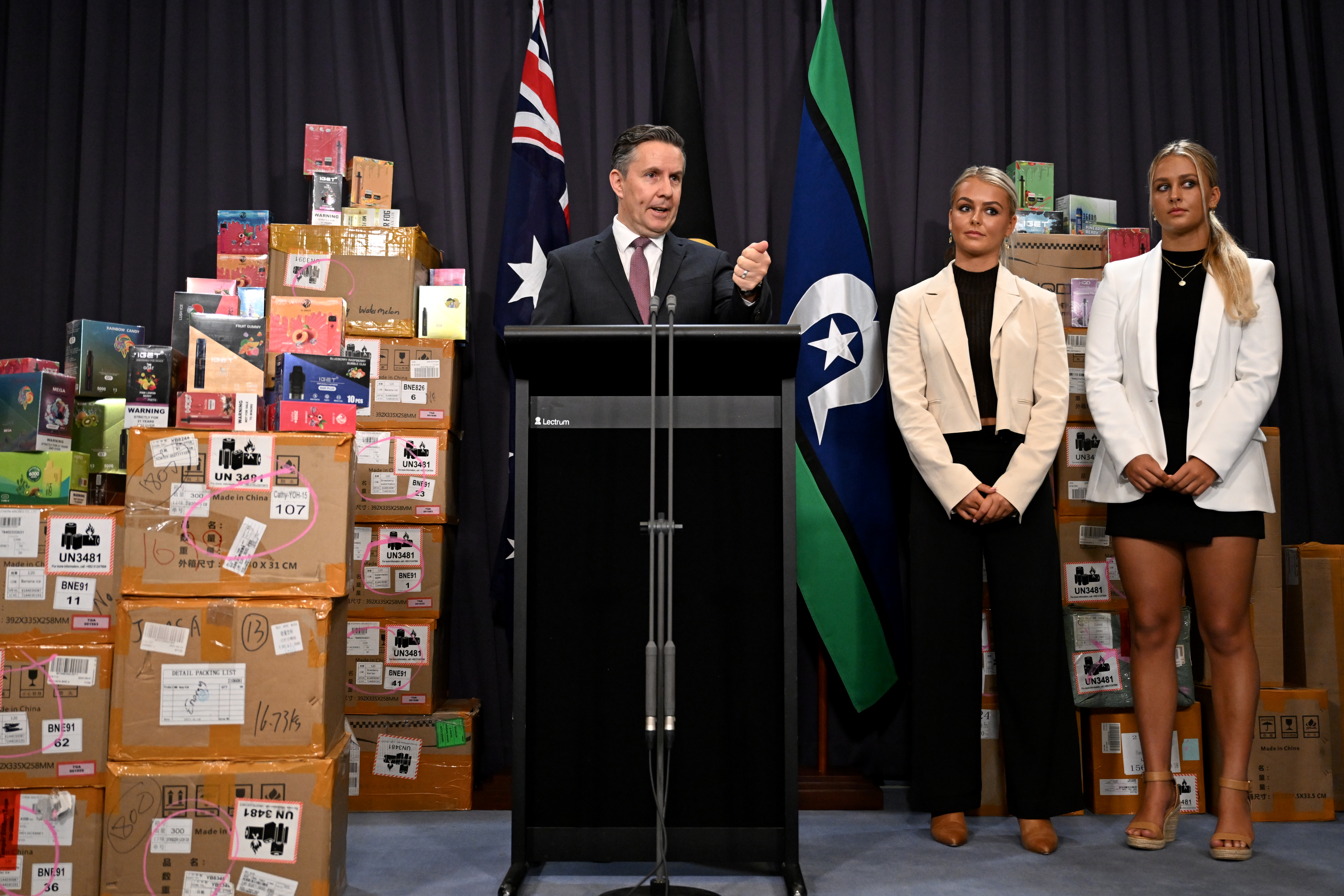 Health Minister Mark Butler with vaping products and social media influencers Zahlia and Shyla Short in February.