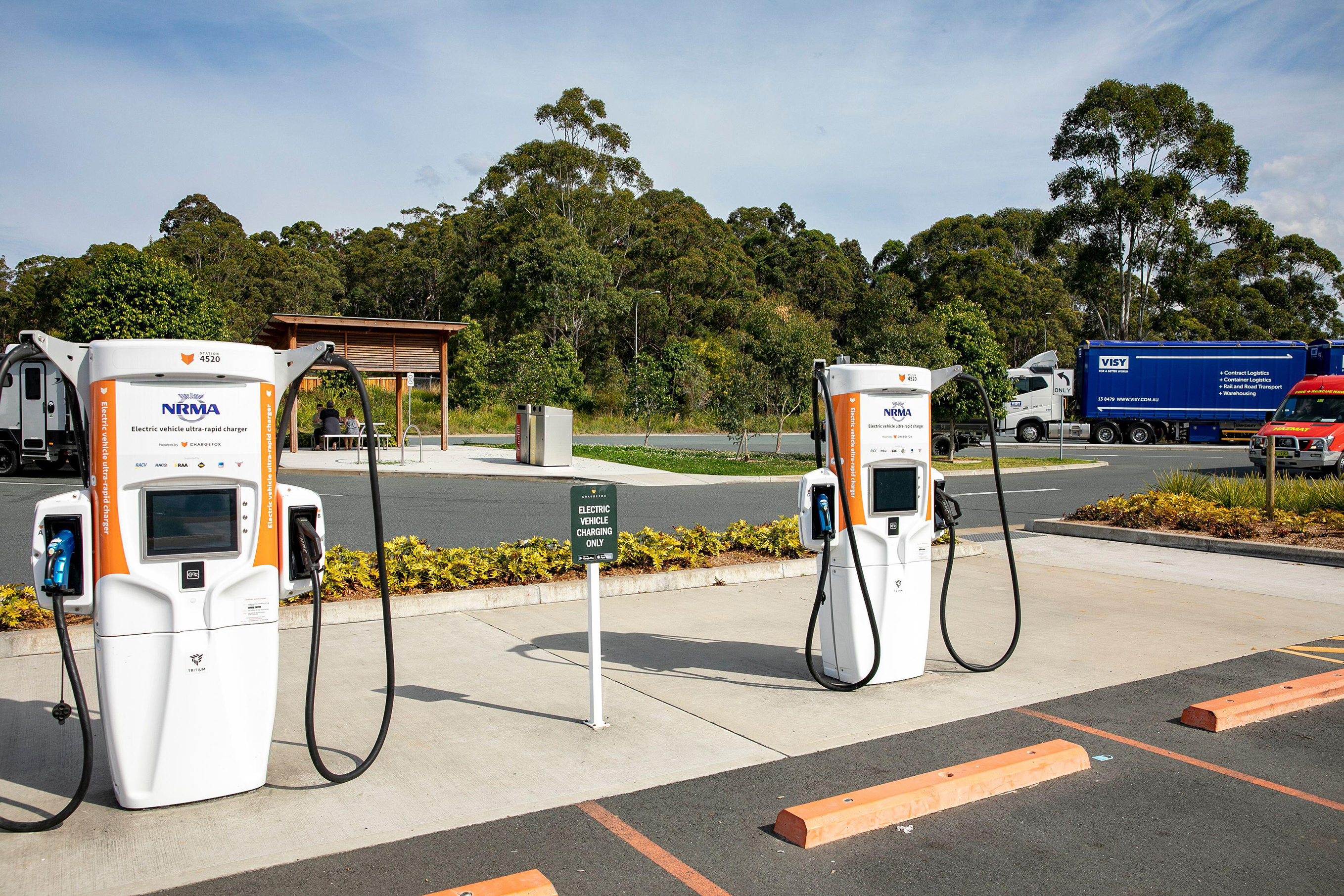 Two EV charging stations beside parking spaces.