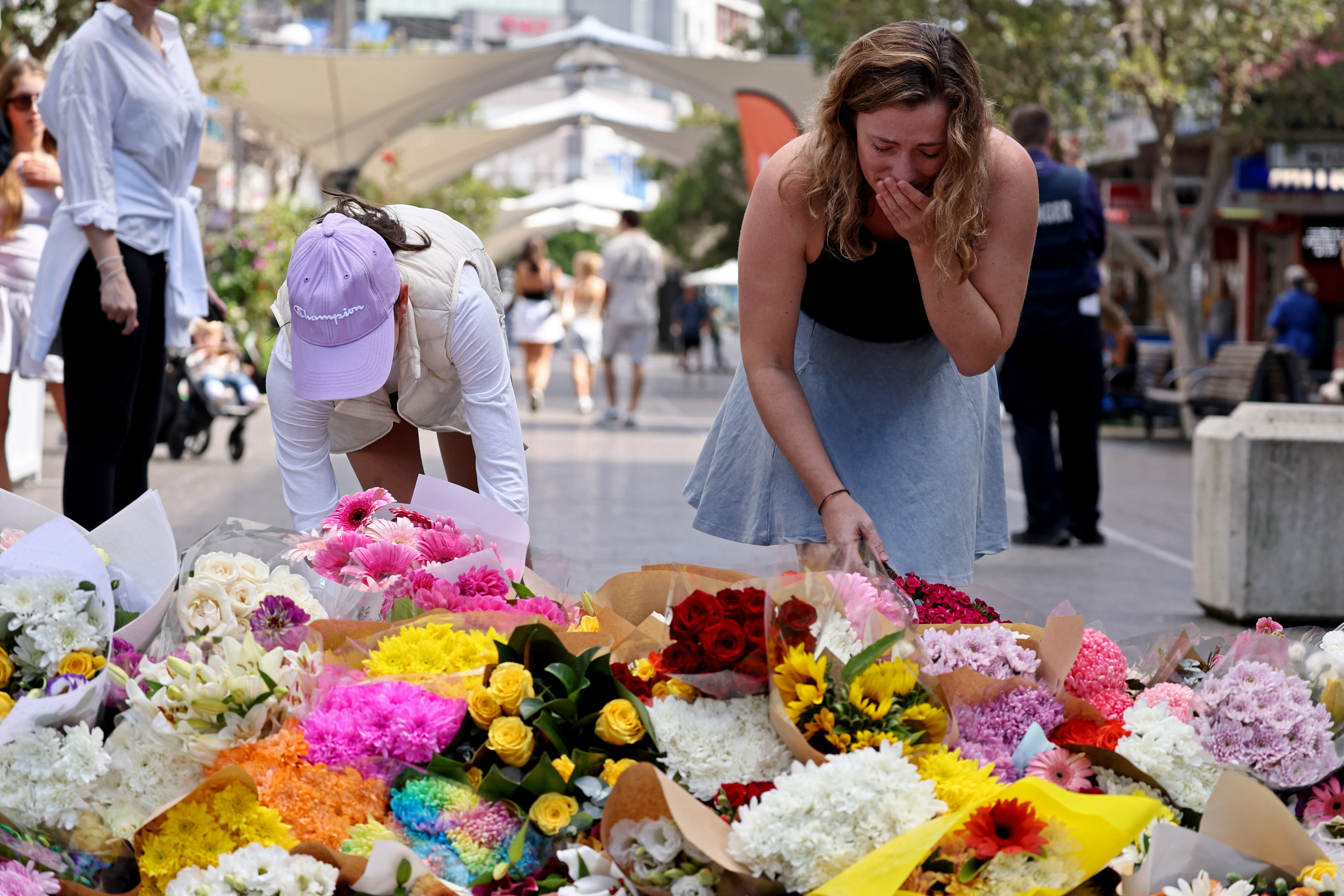 Mourners place flowers at Bondi Junction.