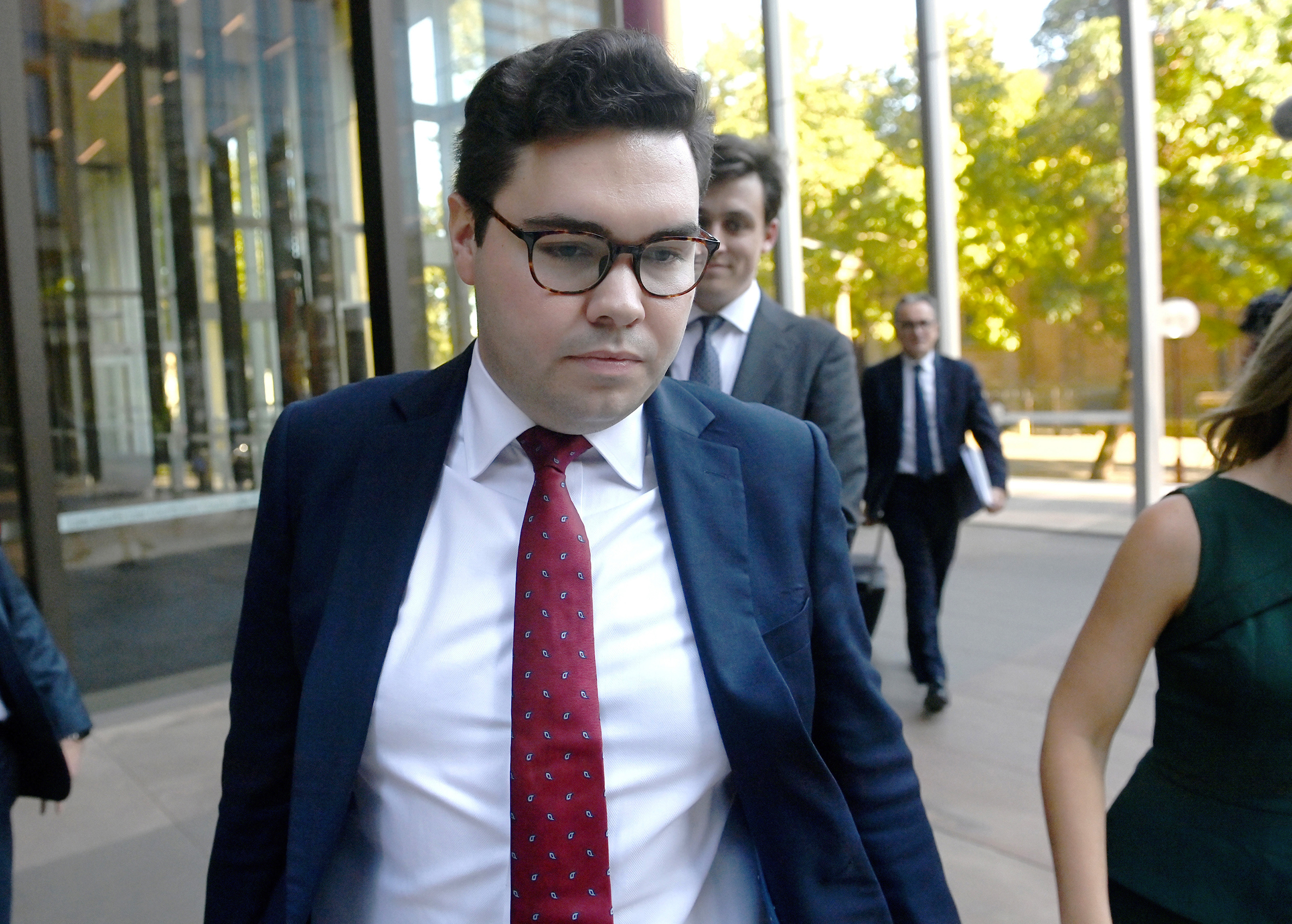 Bruce Lehrmann leaves the Federal Court in Sydney wearing glasses and a suit.