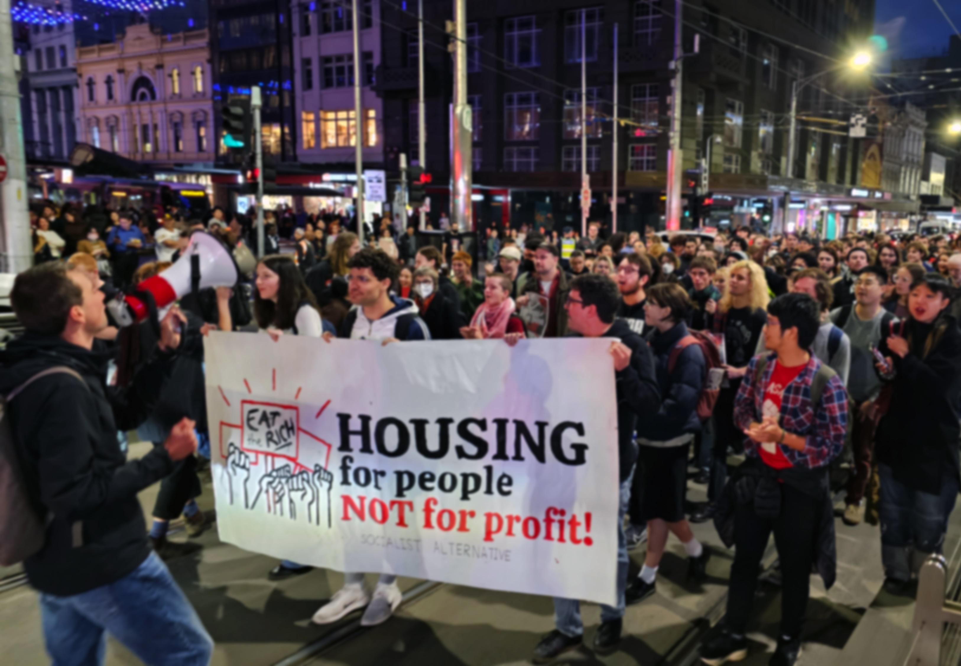 Young protestors occupy a busy street.
