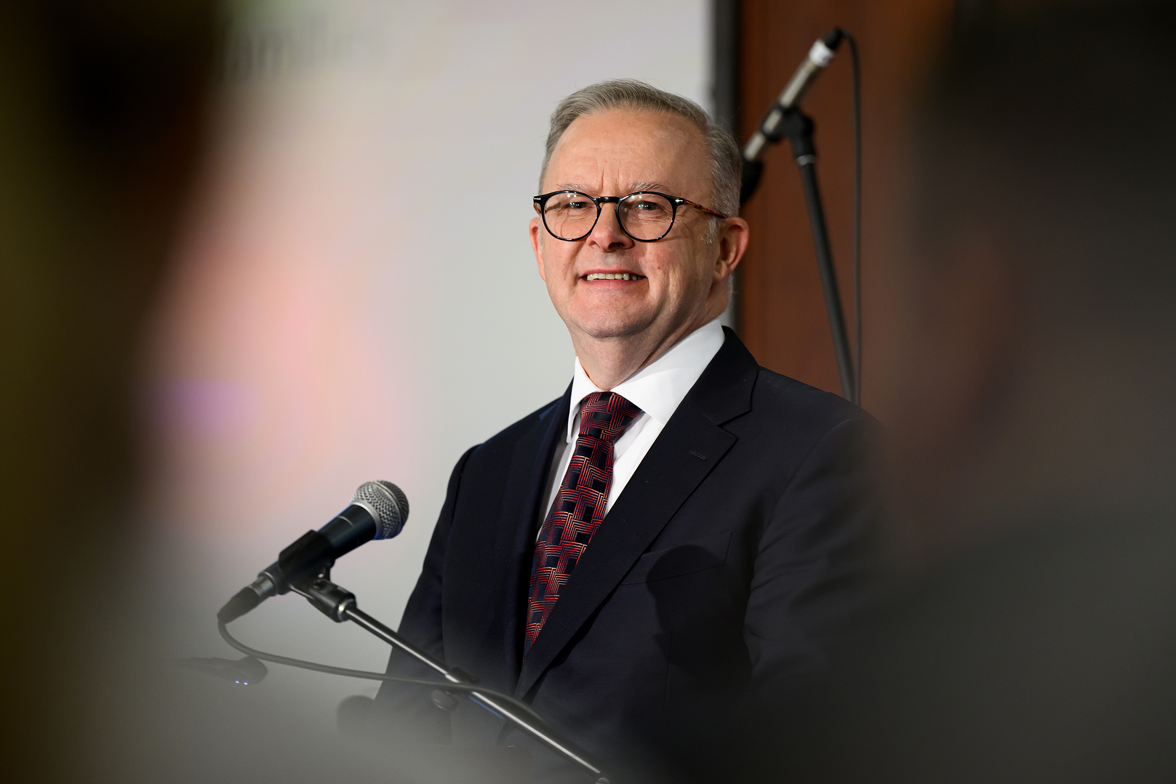Albanese smiling at a press conference.