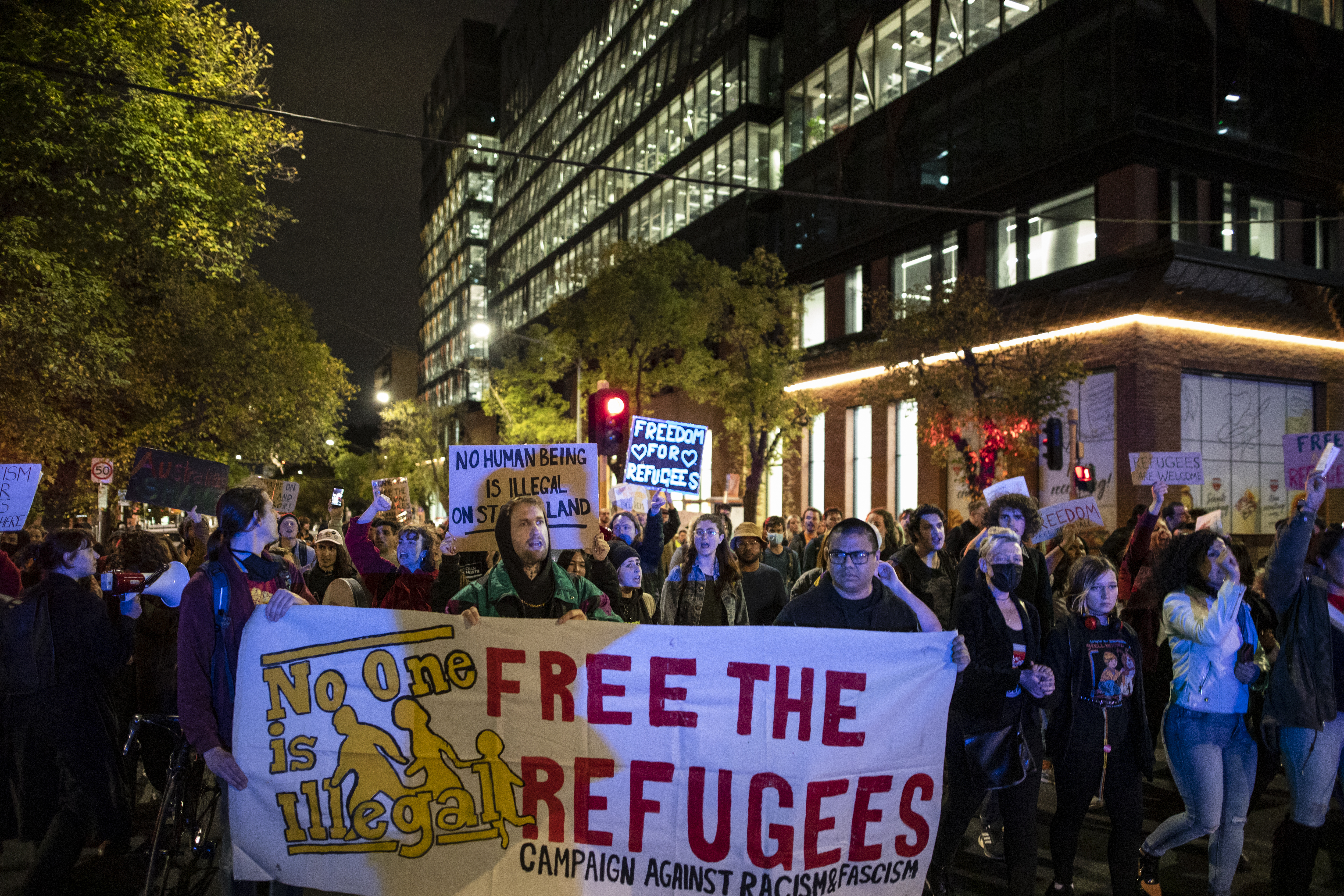Refugees handcuffed, moved again