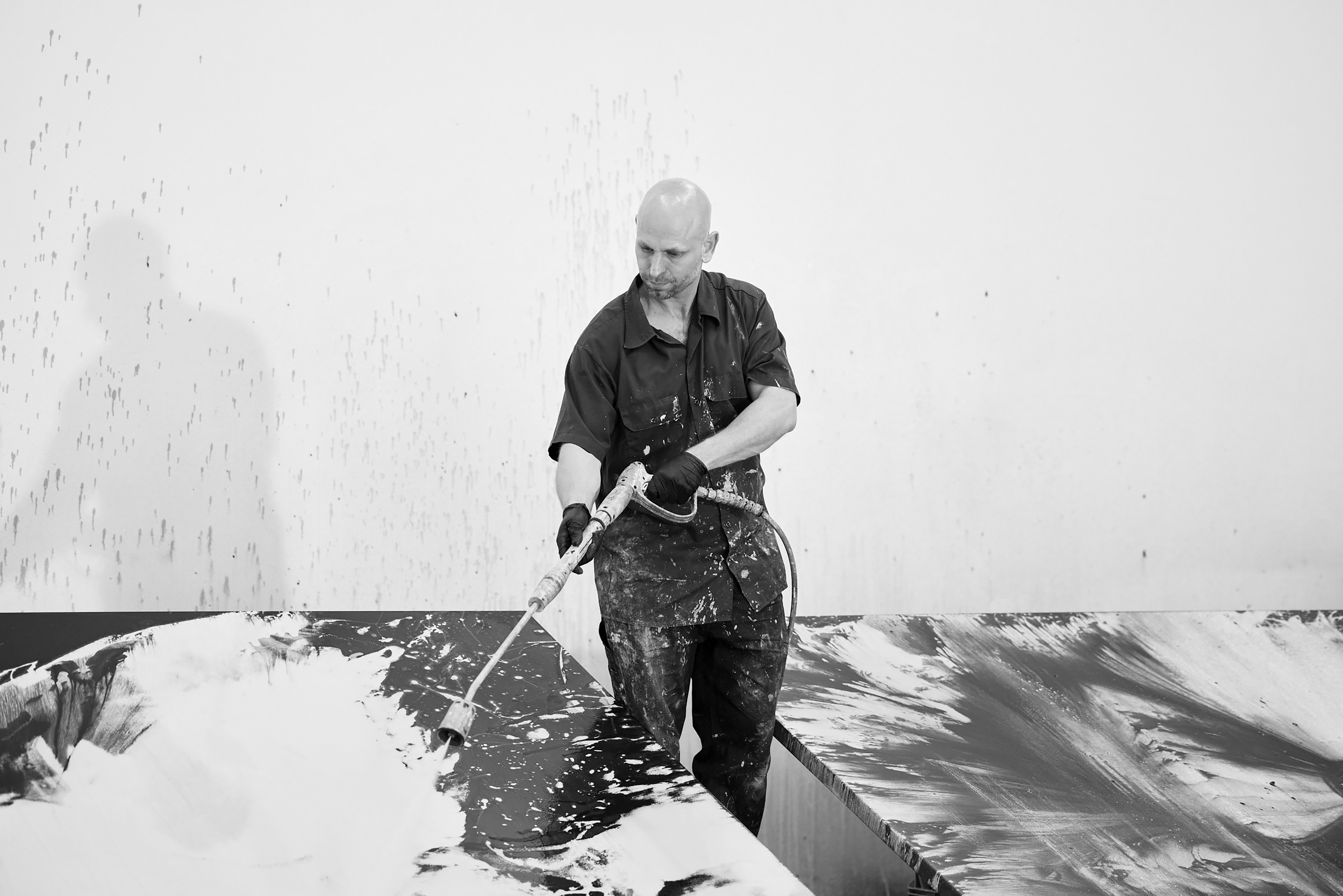 Artist Ash Keating paints a work for his exhibition Pressure at Bunjil Place gallery. 