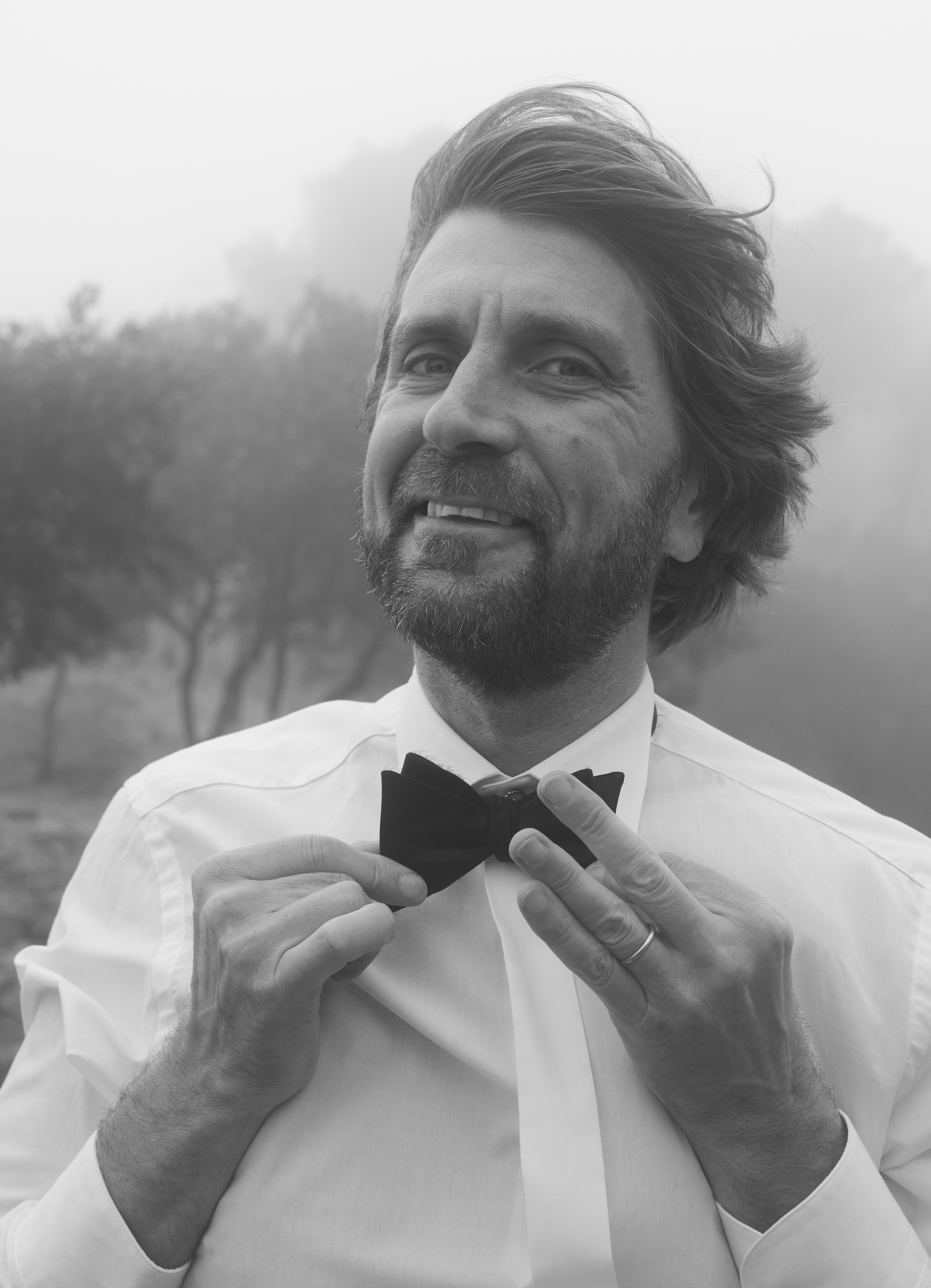 A black and white image of a middle-aged Swedish man with a short beard. He is wearing a formal white shirt and bowtie, and looking at the camera. 