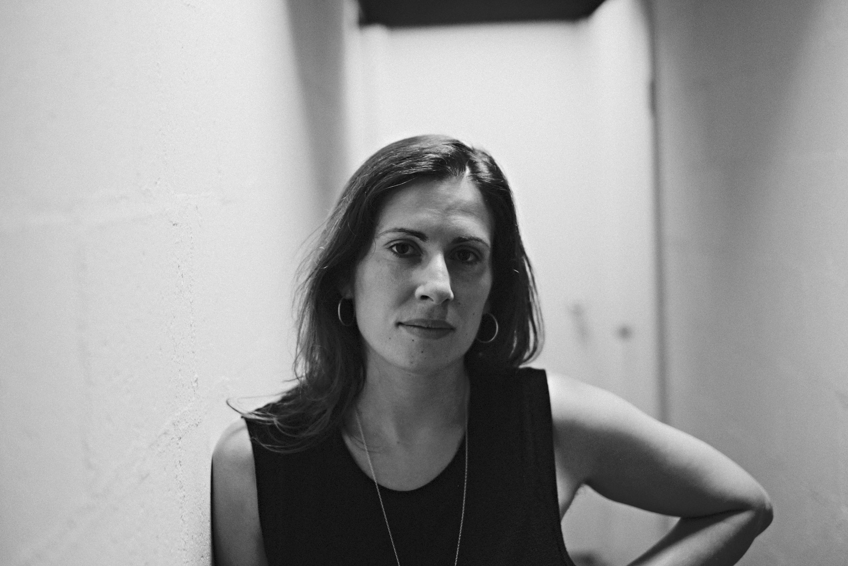 Greyscale portrait image of theatre director Adena Jacobs.