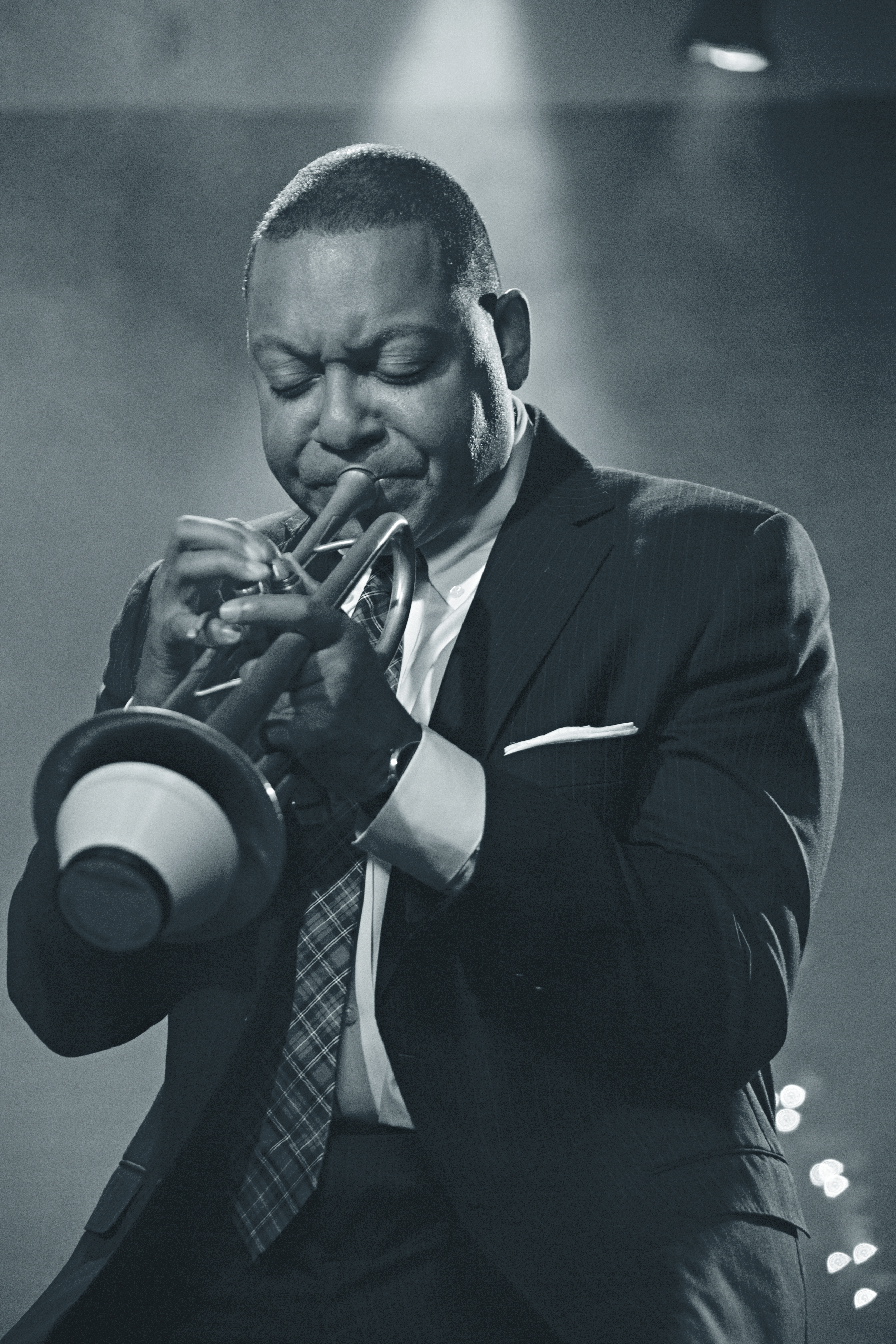 Black & white photograph of a trumpeter performing in a suit.