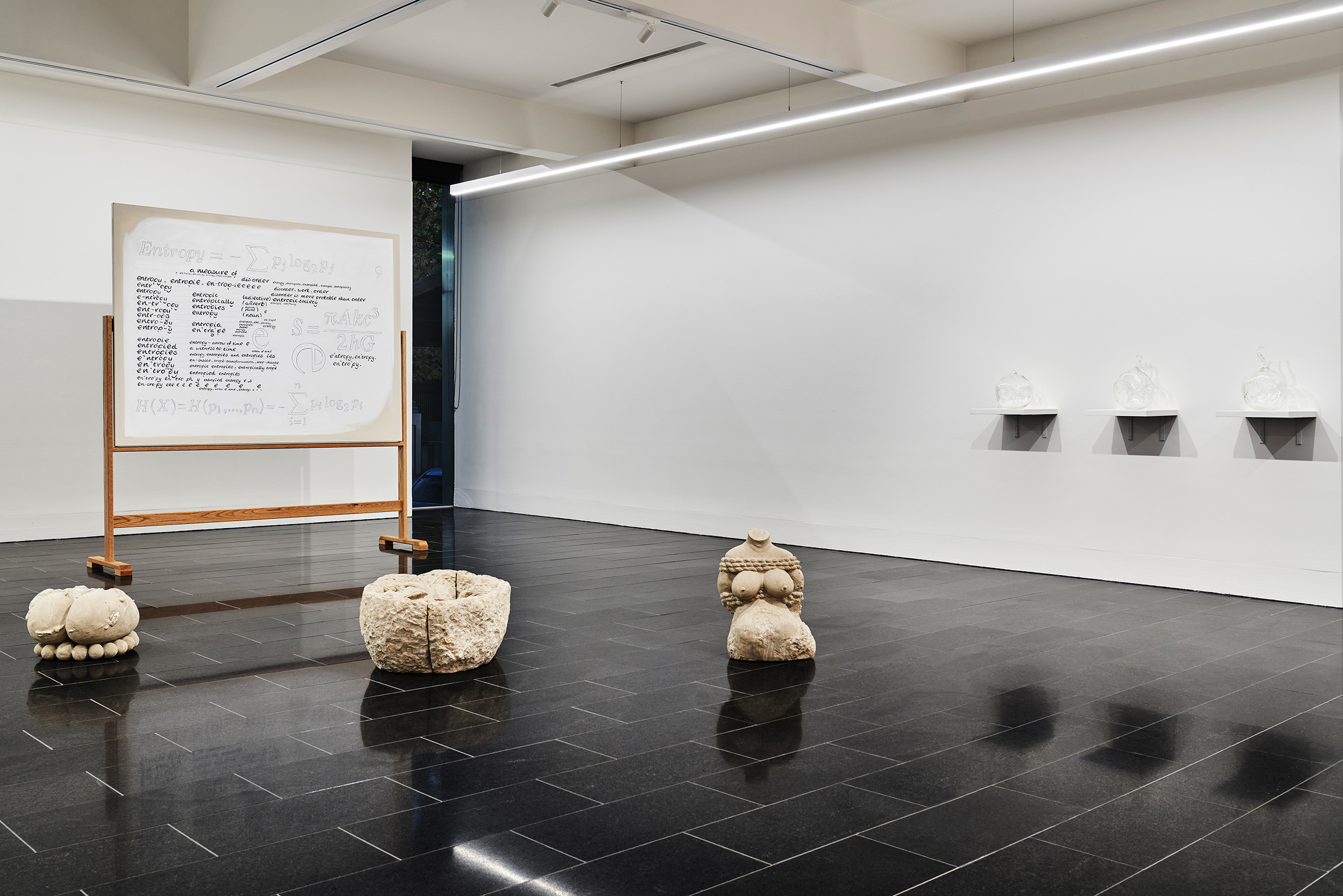 Darcey Bella Arnold’s Entropy painting (at rear), Yhonnie Scarce’s Florey and Fanny and Nucleus (U235) 1-3 (on wall) and Noriko Nakamura’s Womb realm (on floor).