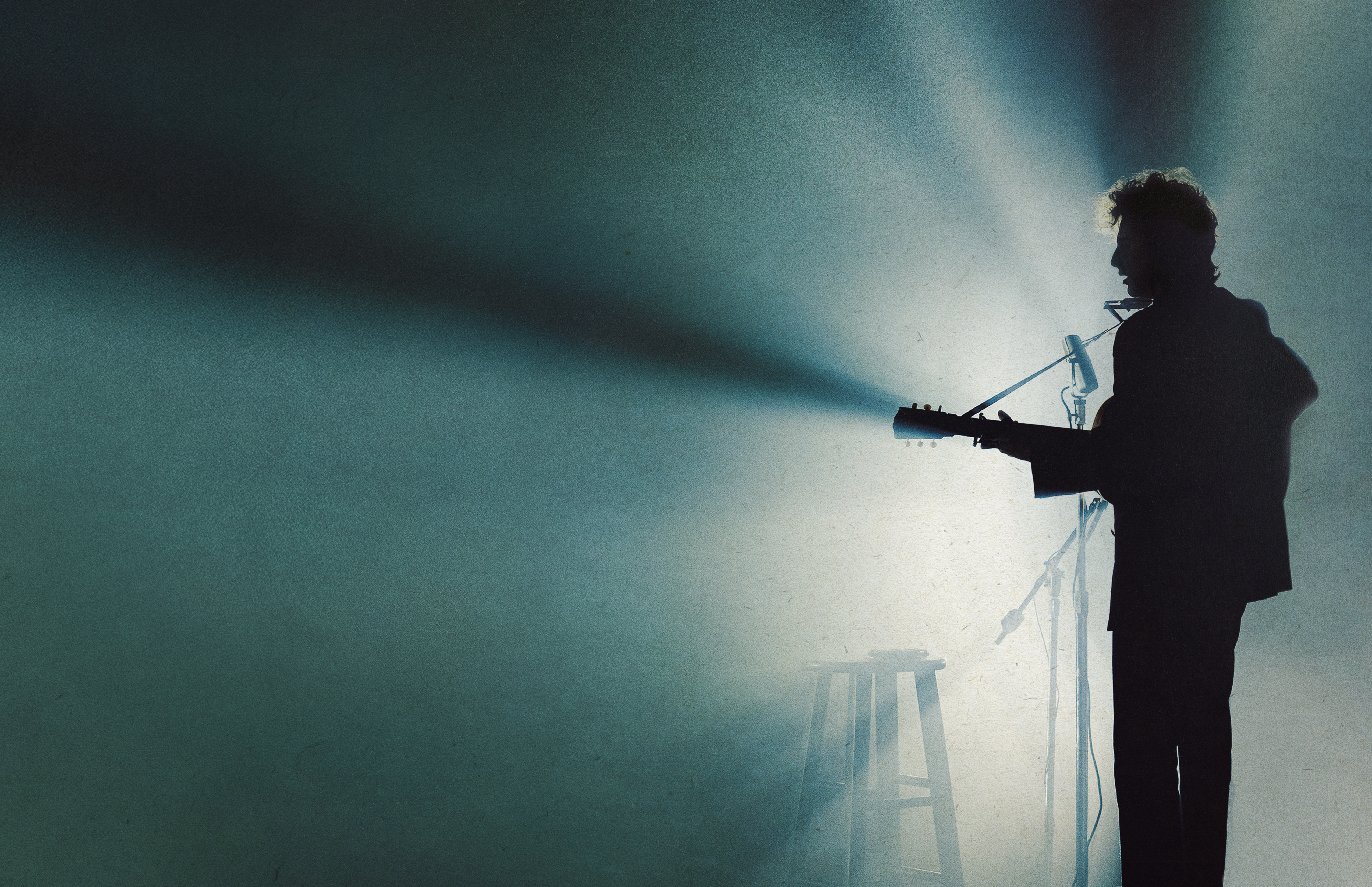 A silhouette of Timothée Chalamet performing as Bob Dylan