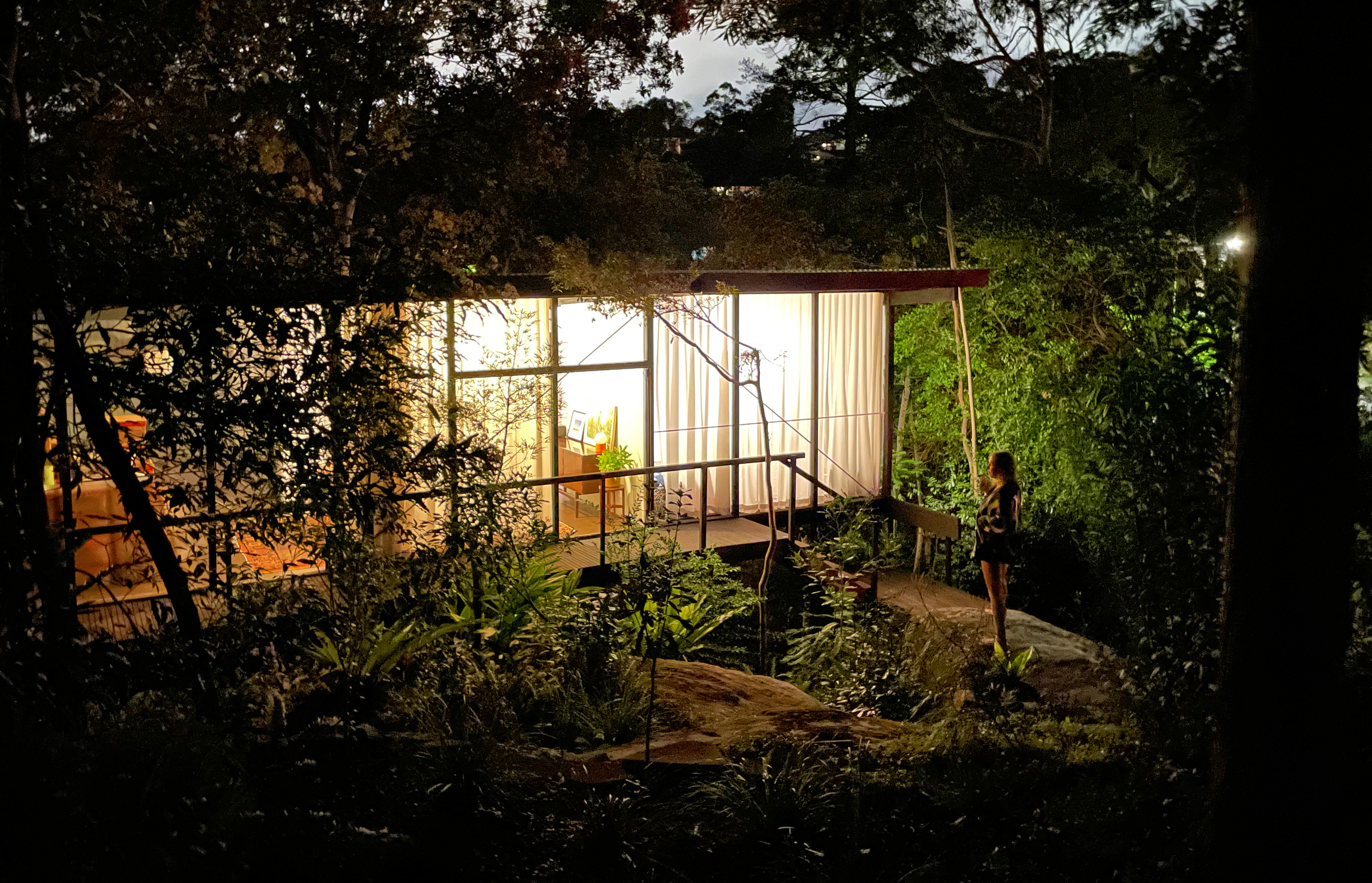 The Lucas Glass House illuminated in the night.