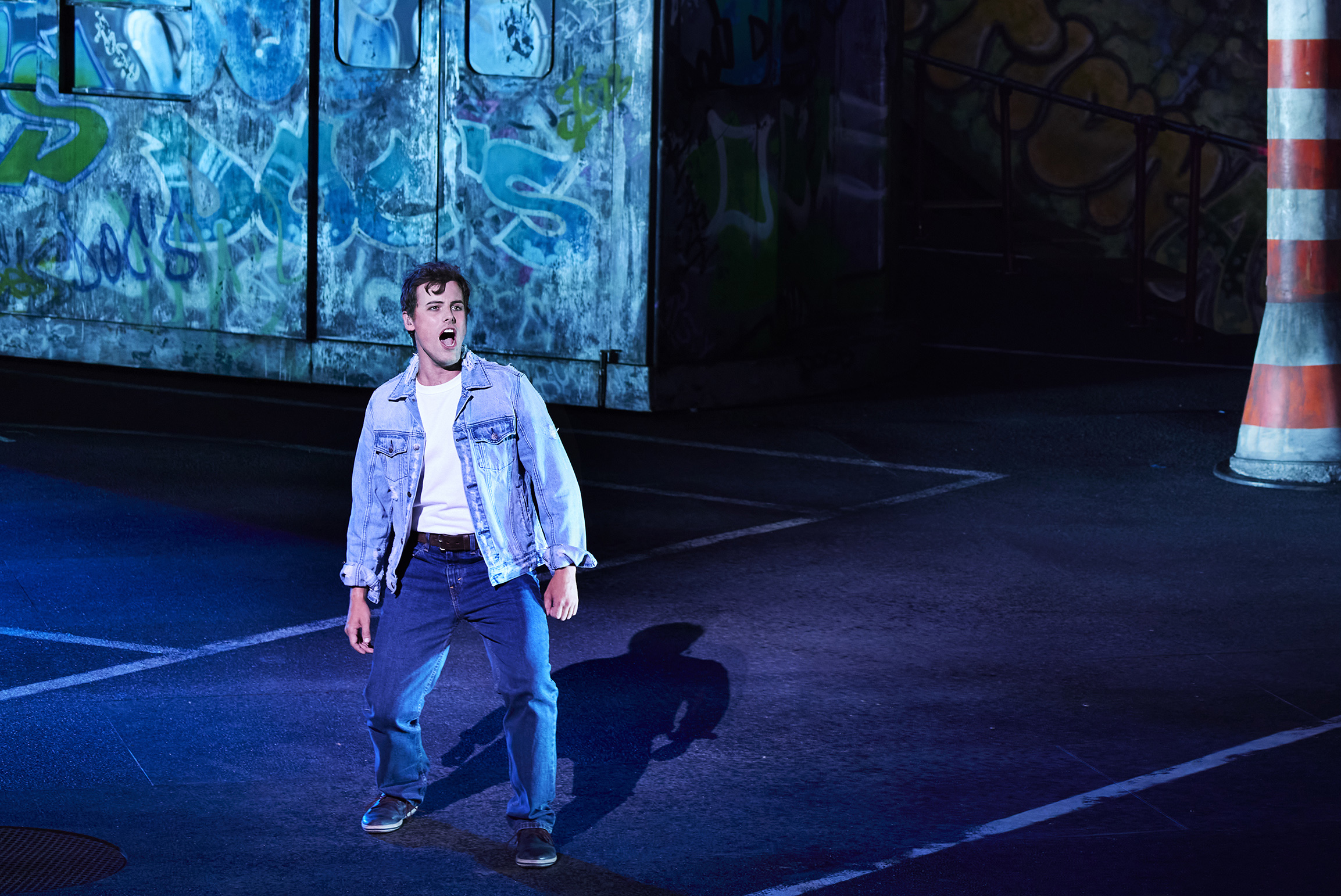 A performer sings in a double-denim outfit.