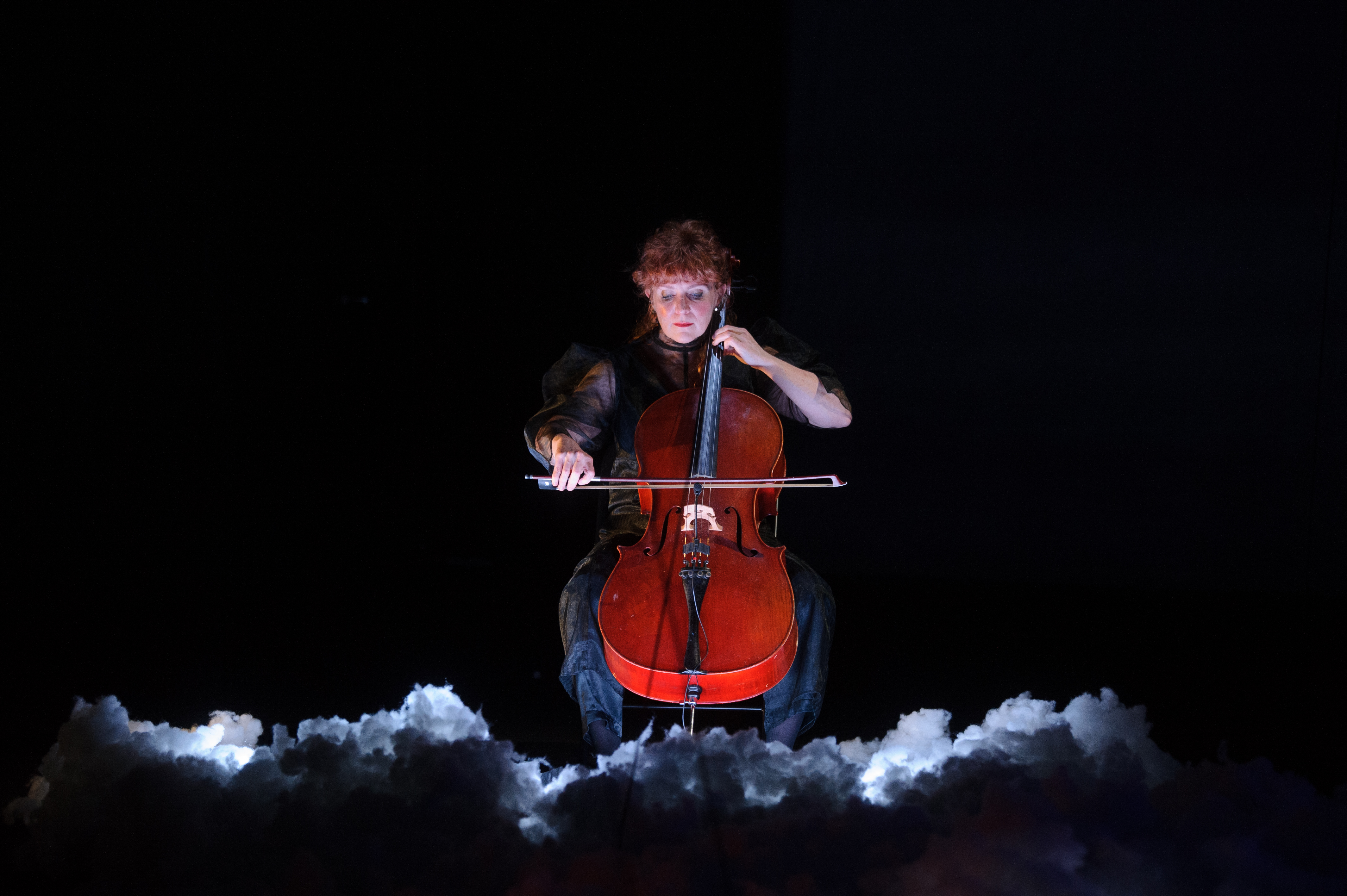 A cellist performs with on stage.