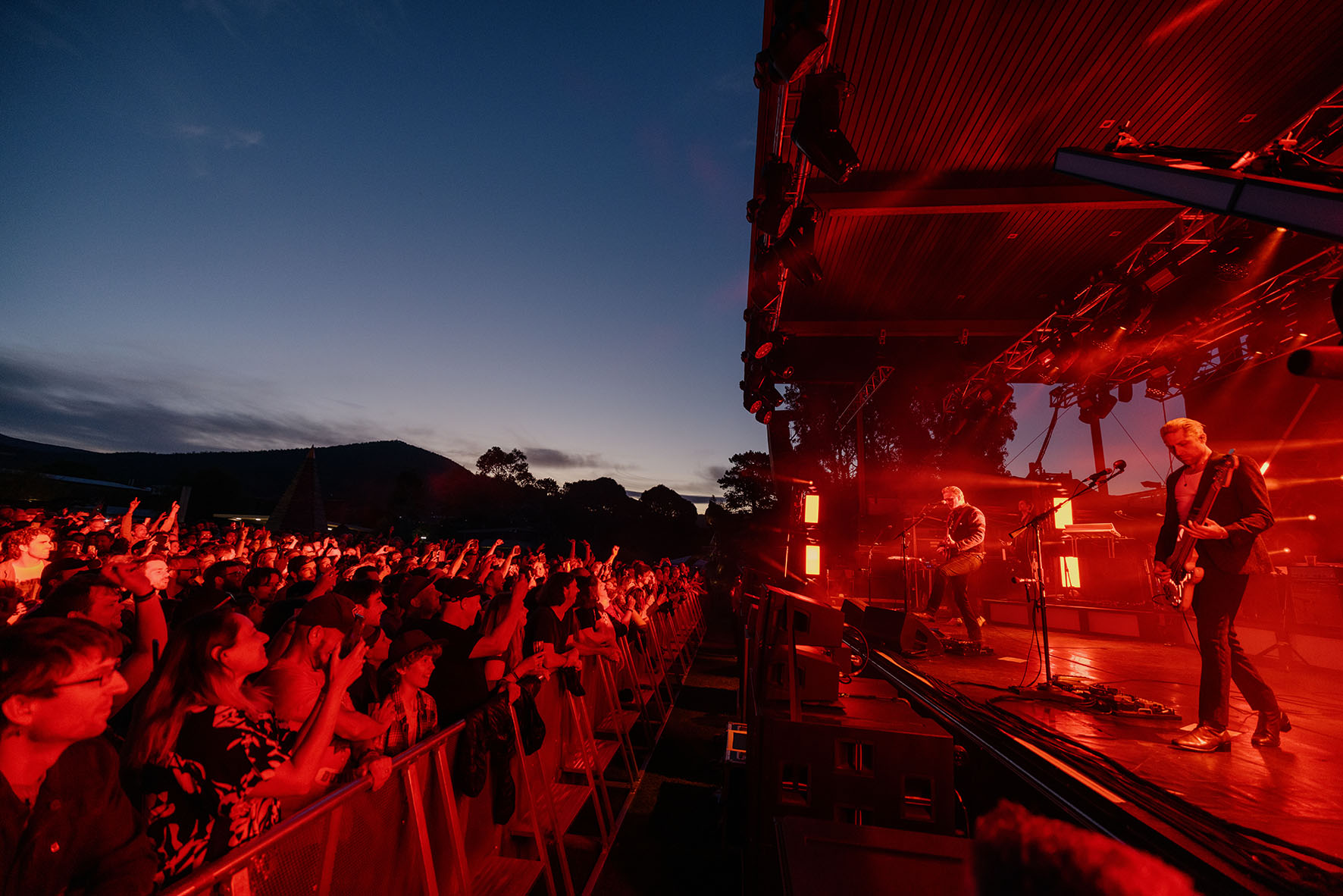 A band drenched in red stage lights.