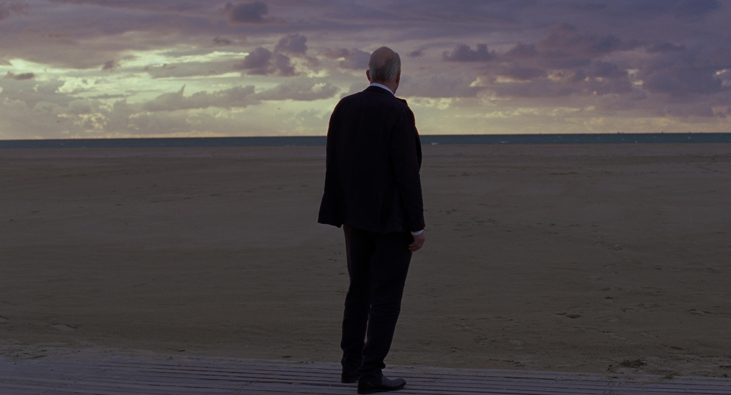 Stellan Skarskard on the beach in a scene from Sentimental Value.