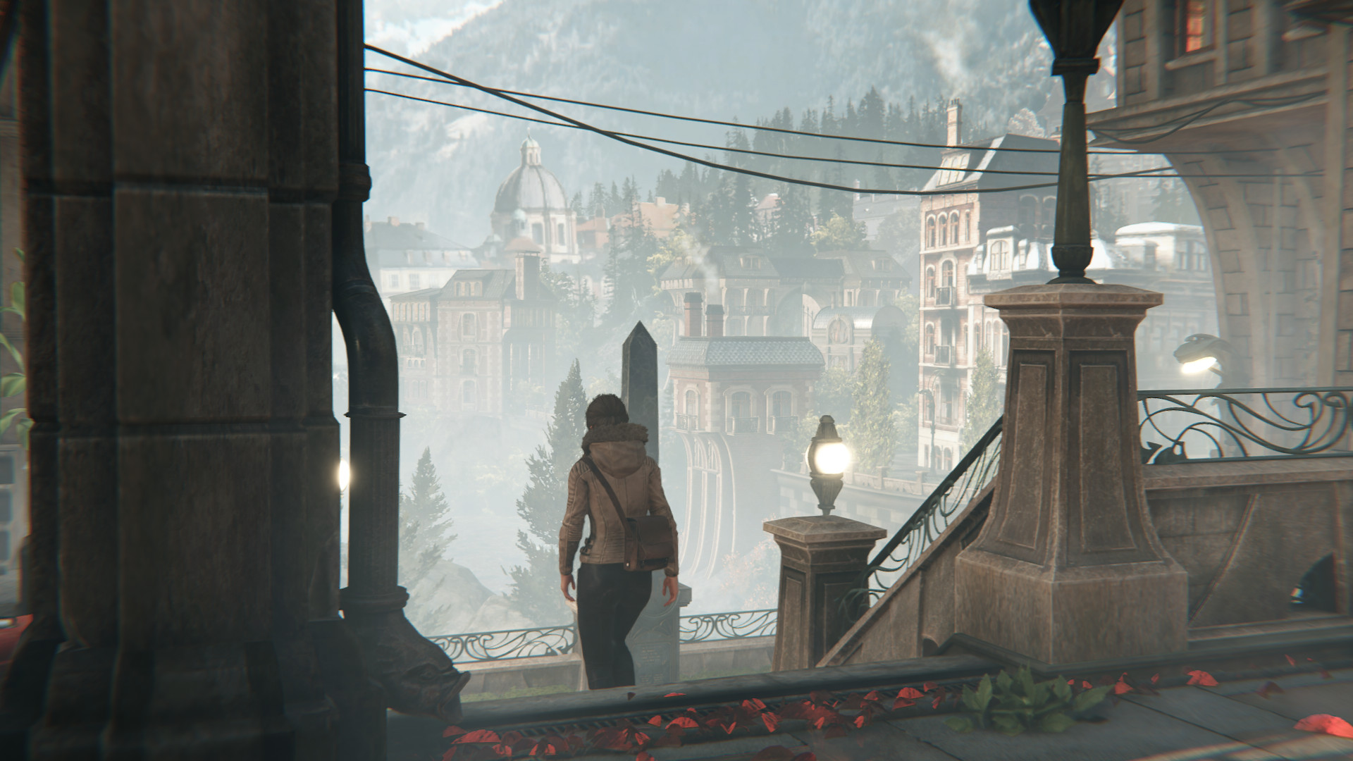 The character Kate Walker walking down steps that look out to a vast valley.