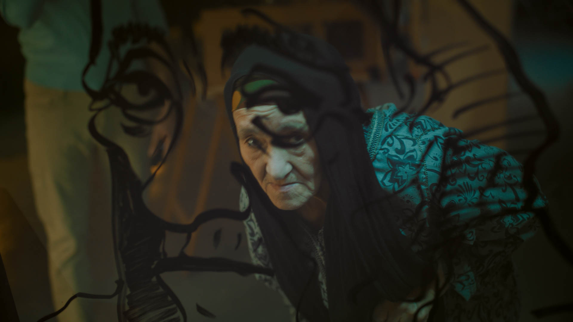 An elderly woman hunched over in the darkness.