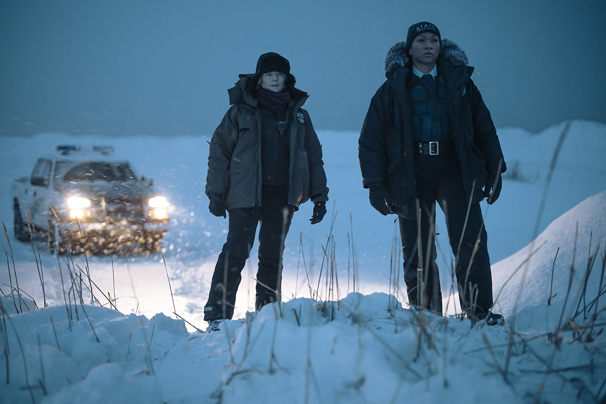 Two detectives standing in the snow.