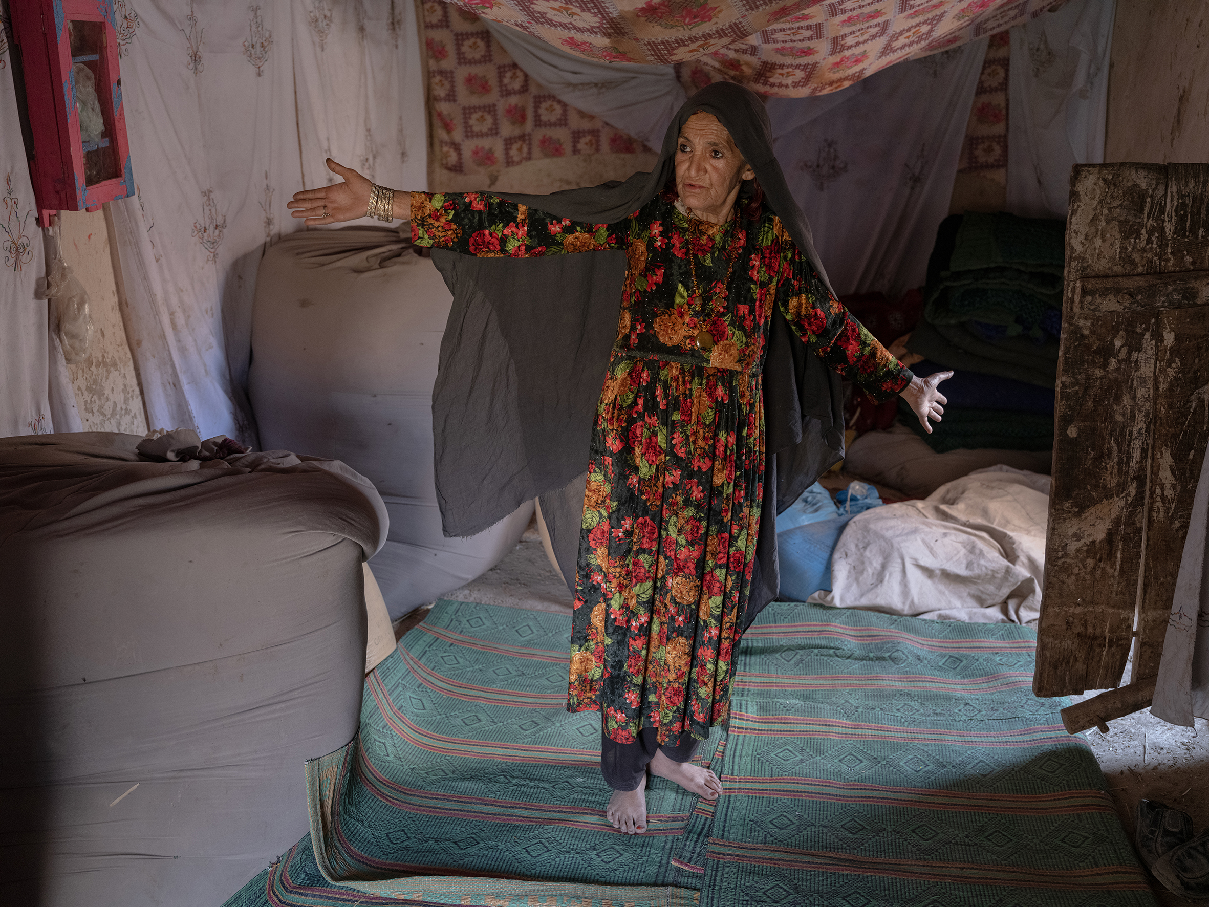 A small room filled with sheets and rugs.