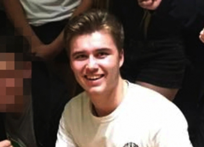 A young man in a white t-shirt.