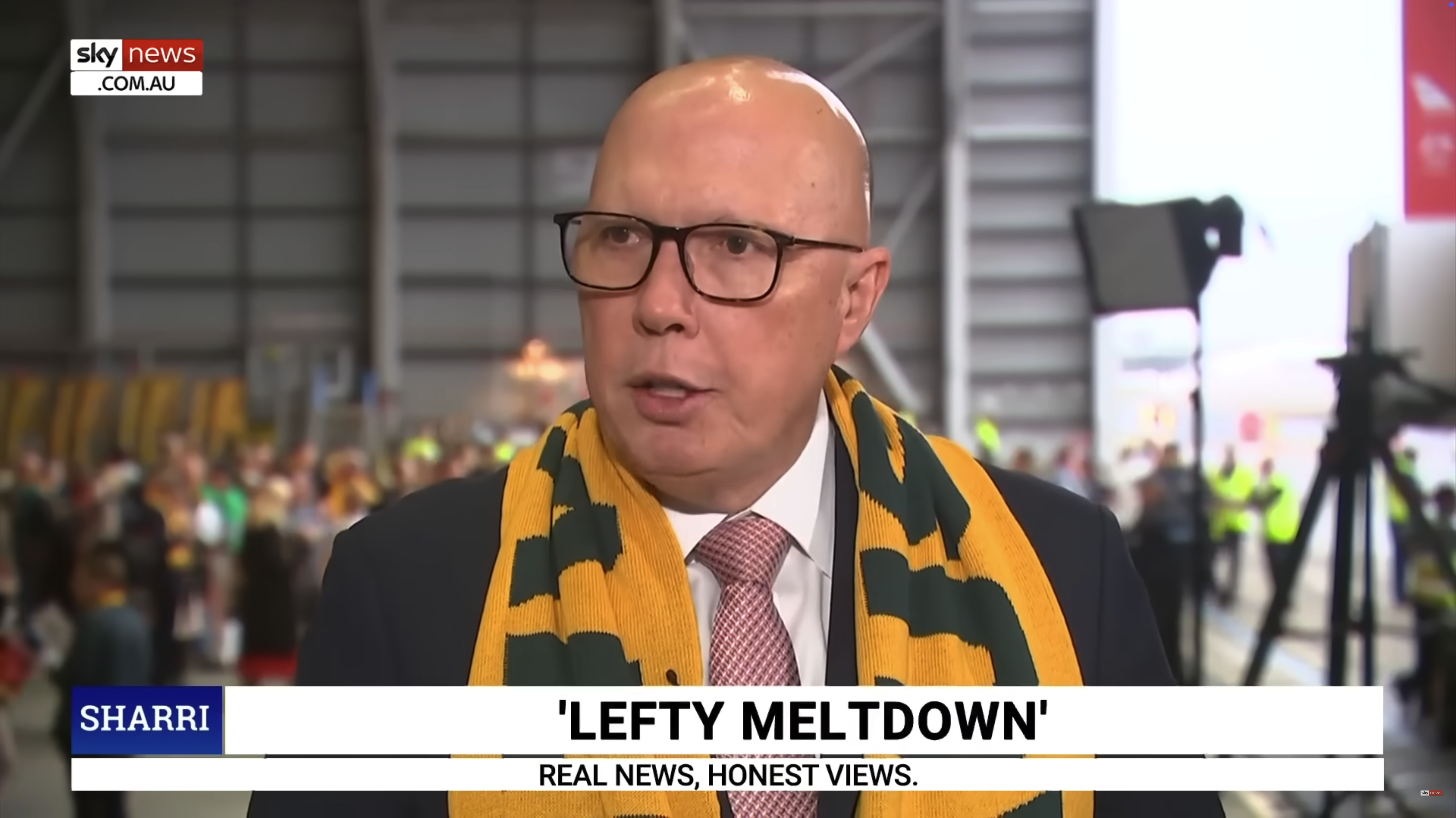 Peter Dutton wearing a green and gold scarf on Sky News.
